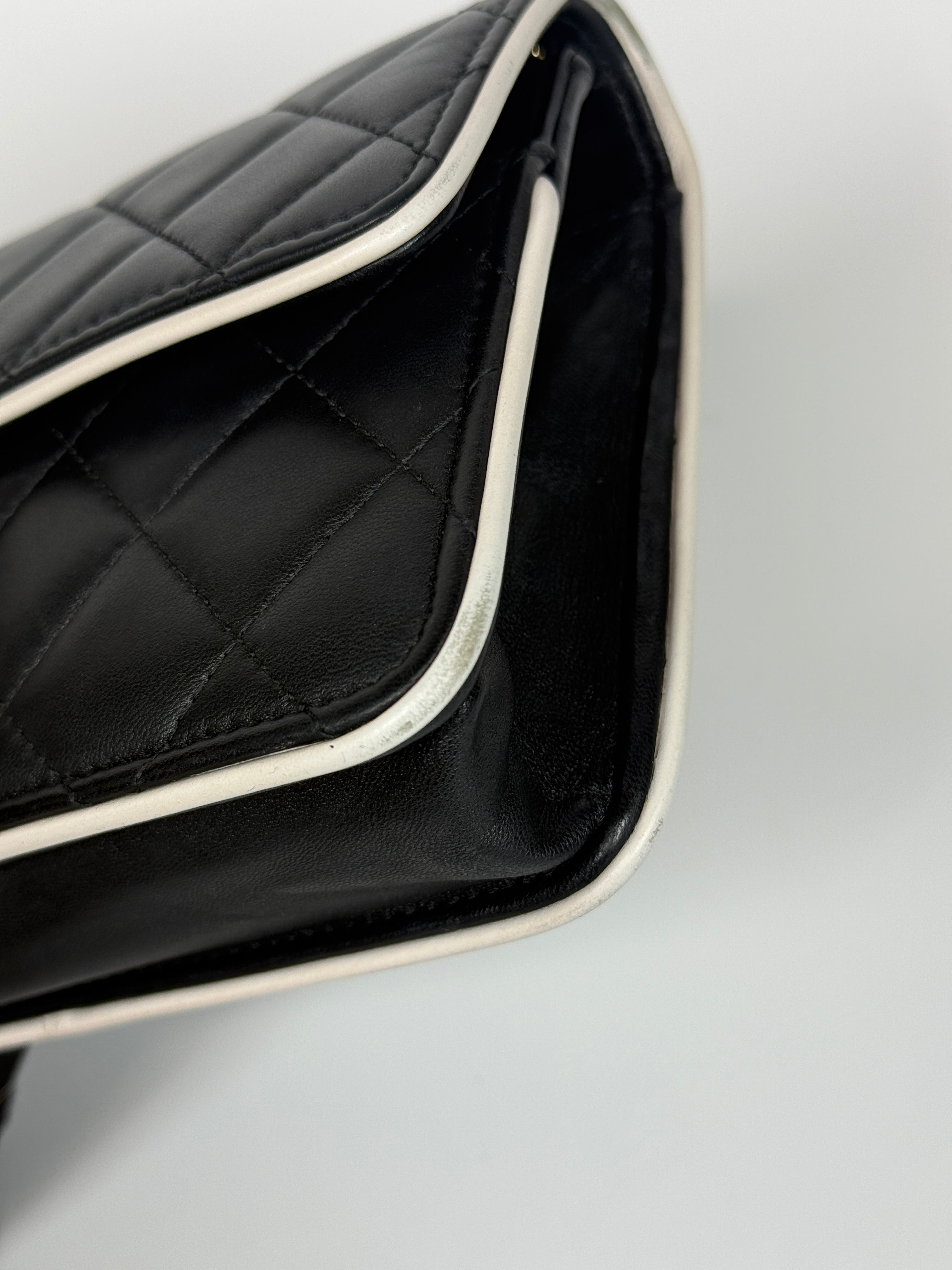 Authentic and preloved Chanel Wallet On Chain In Black & White Lambskin Leather With Pale Gold Hardware. Very Good Condition. 100% Authenticity Guarantee 