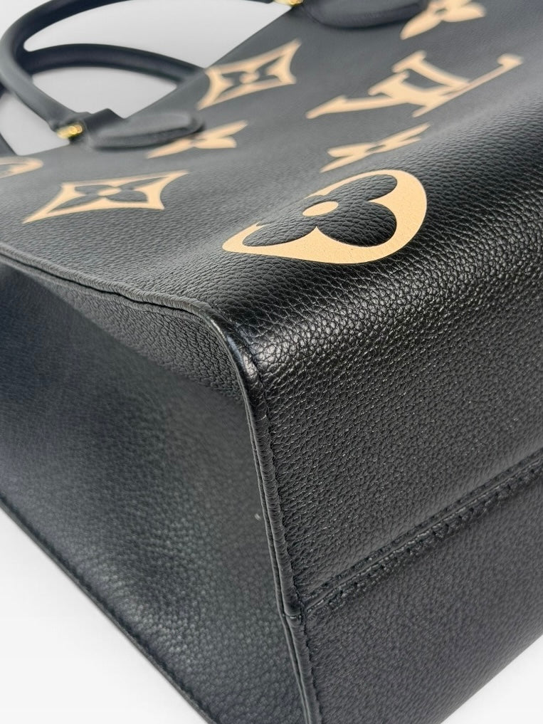 Louis Vuitton On The Go MM Tote In Black & Beige Leather With Gold Hardware. 100% authentic and preloved in excellent condition