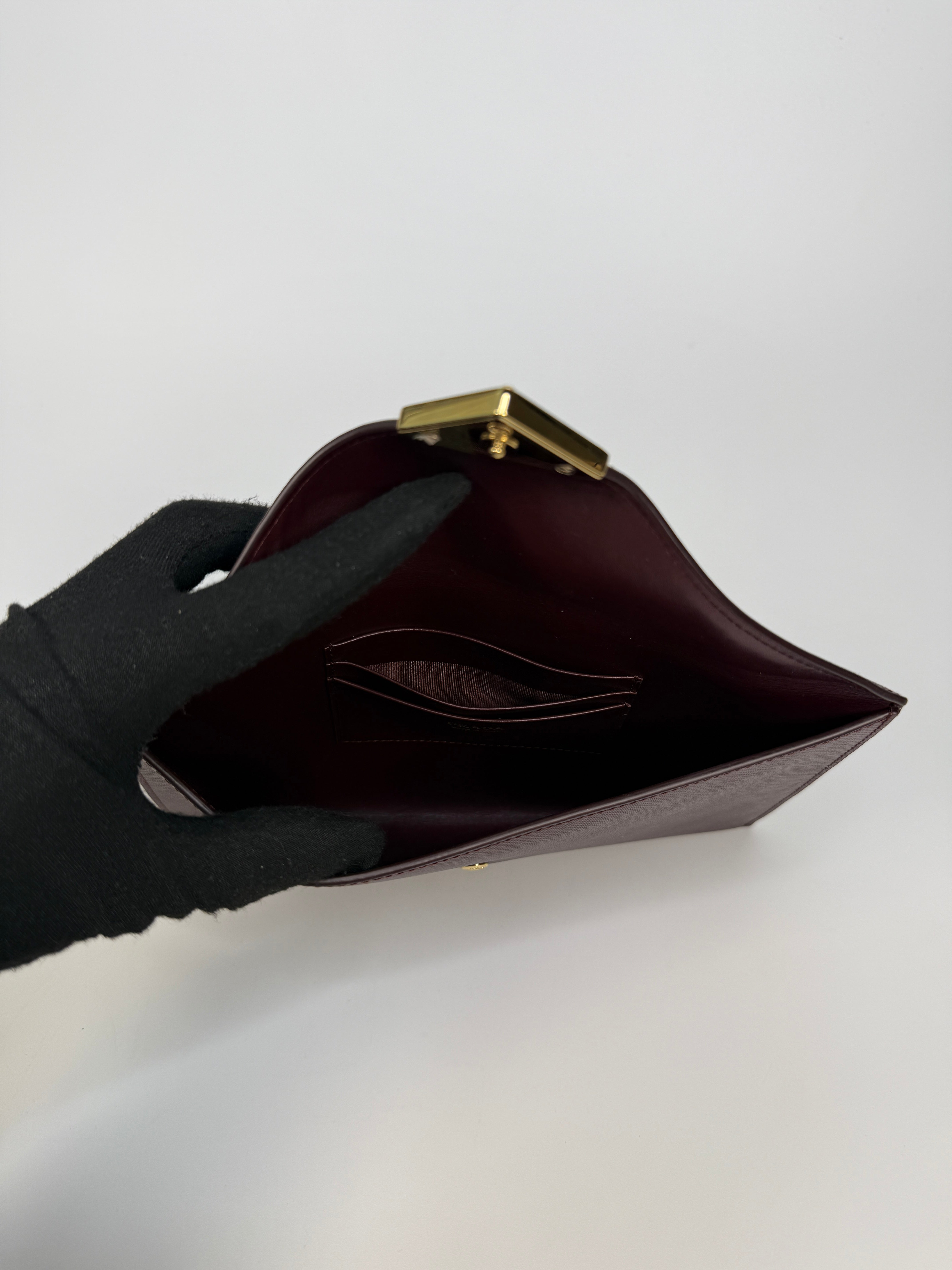 Prada Clutch In Burgundy Saffiano Leather With Gold Hardware