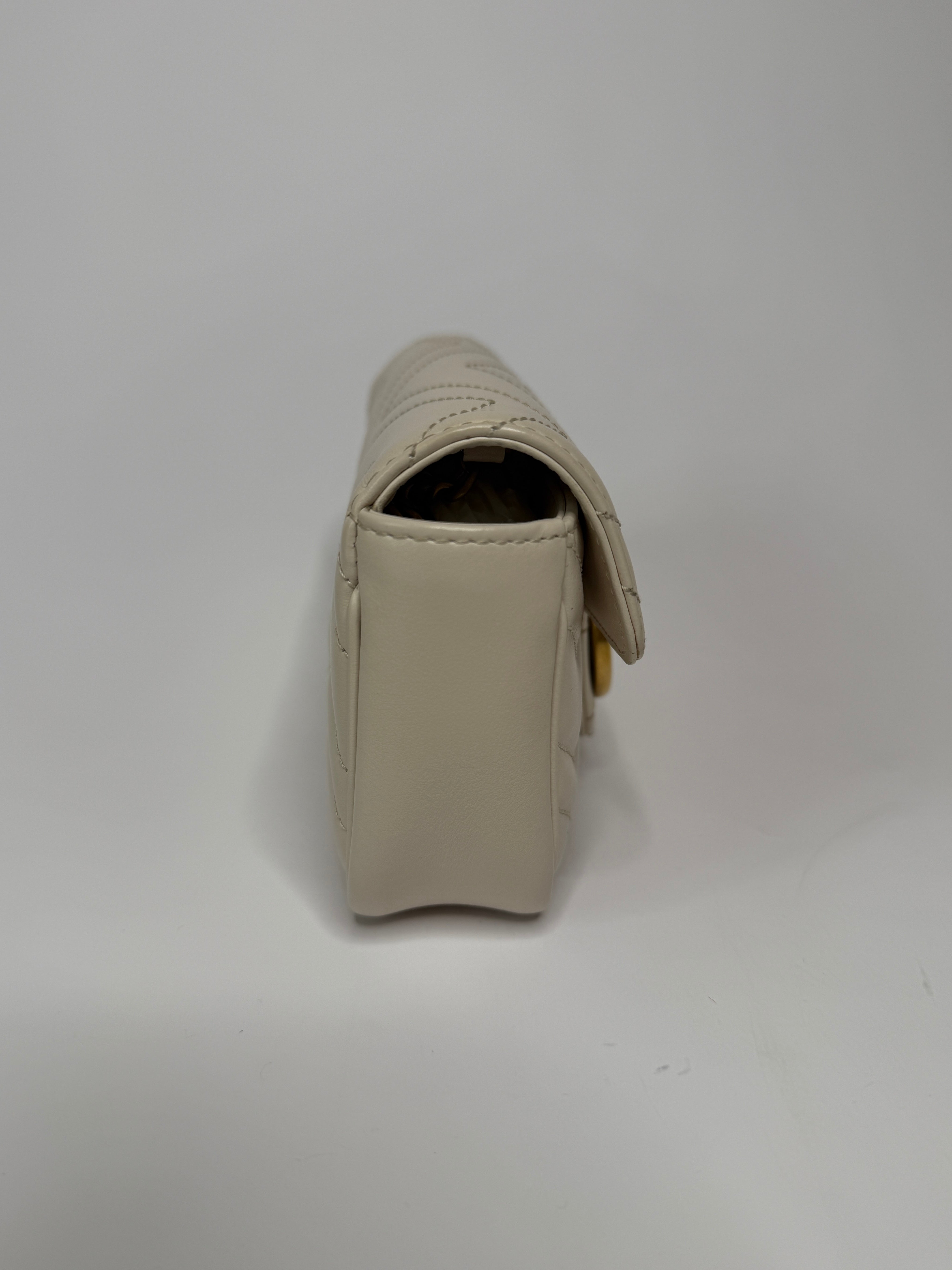 Gucci Marmont White  Matelassé Super Mini Bag With Gold Hardware In Excellent pre loved condition. Authentic and preloved
