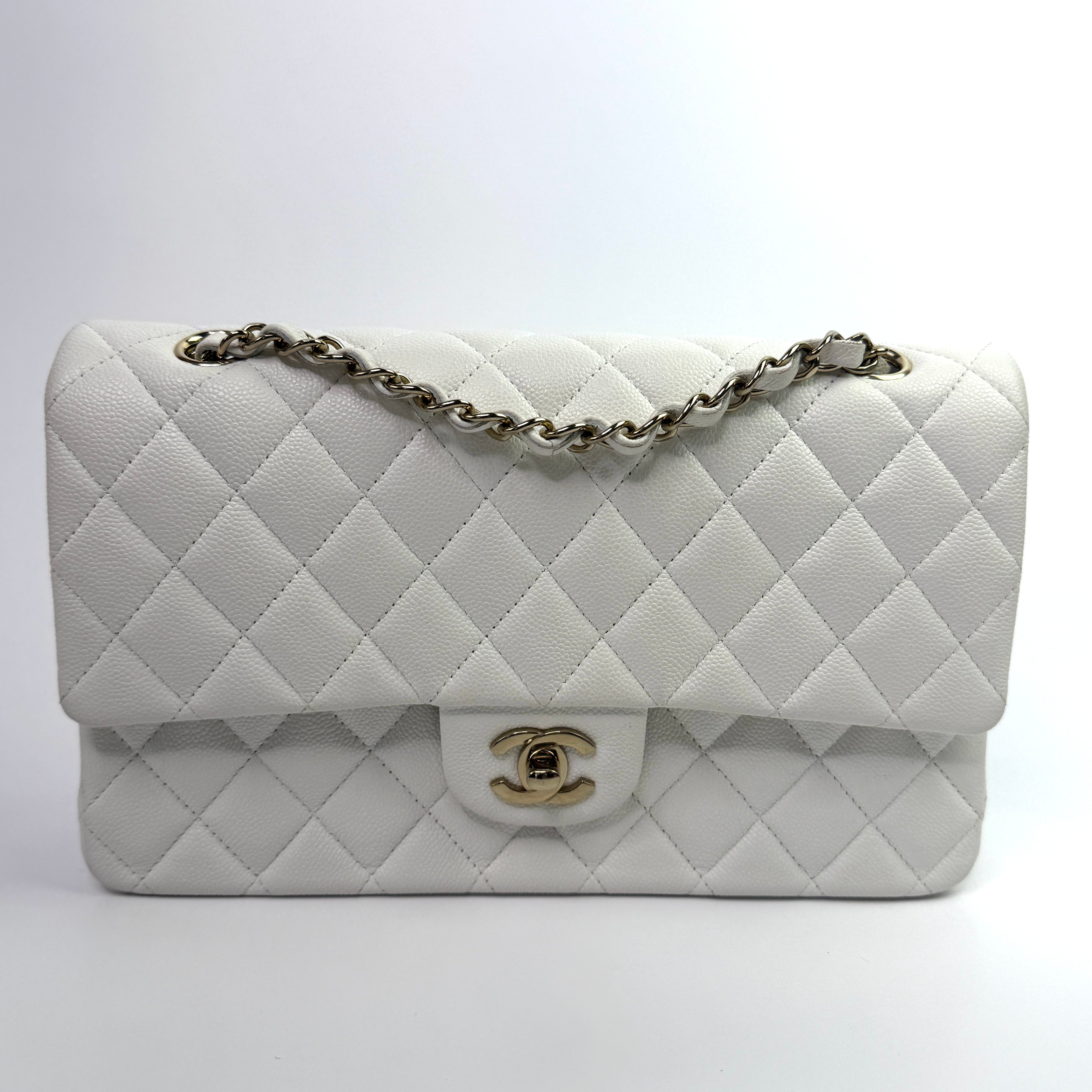 Authentic pre-loved Chanel Medium Classic Double Flap White Caviar Leather With Gold Hardware. 