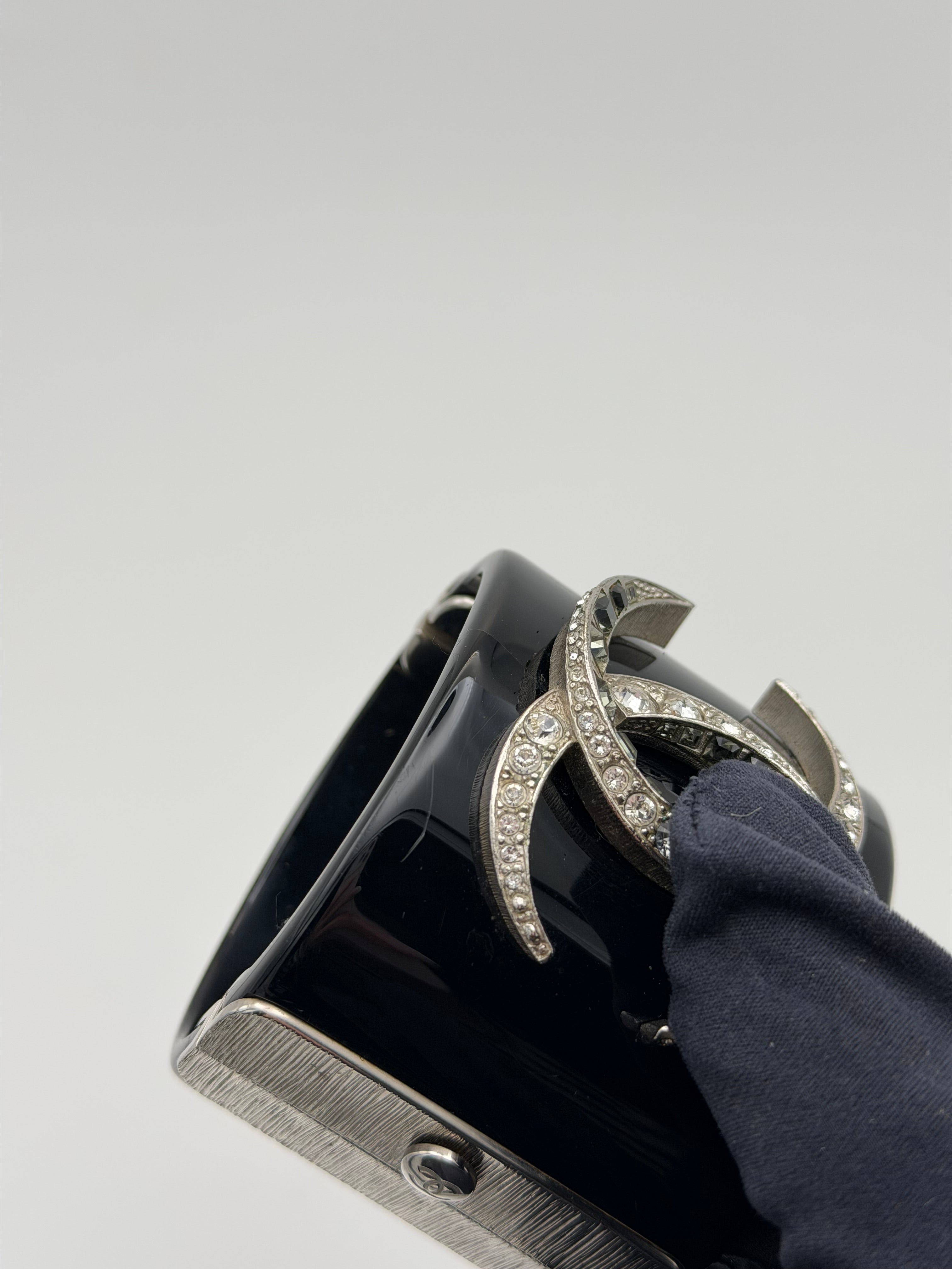 Chanel cc Black resin and rhinestone cuff in black enamel. Very Good condition. Authentic and preloved. 