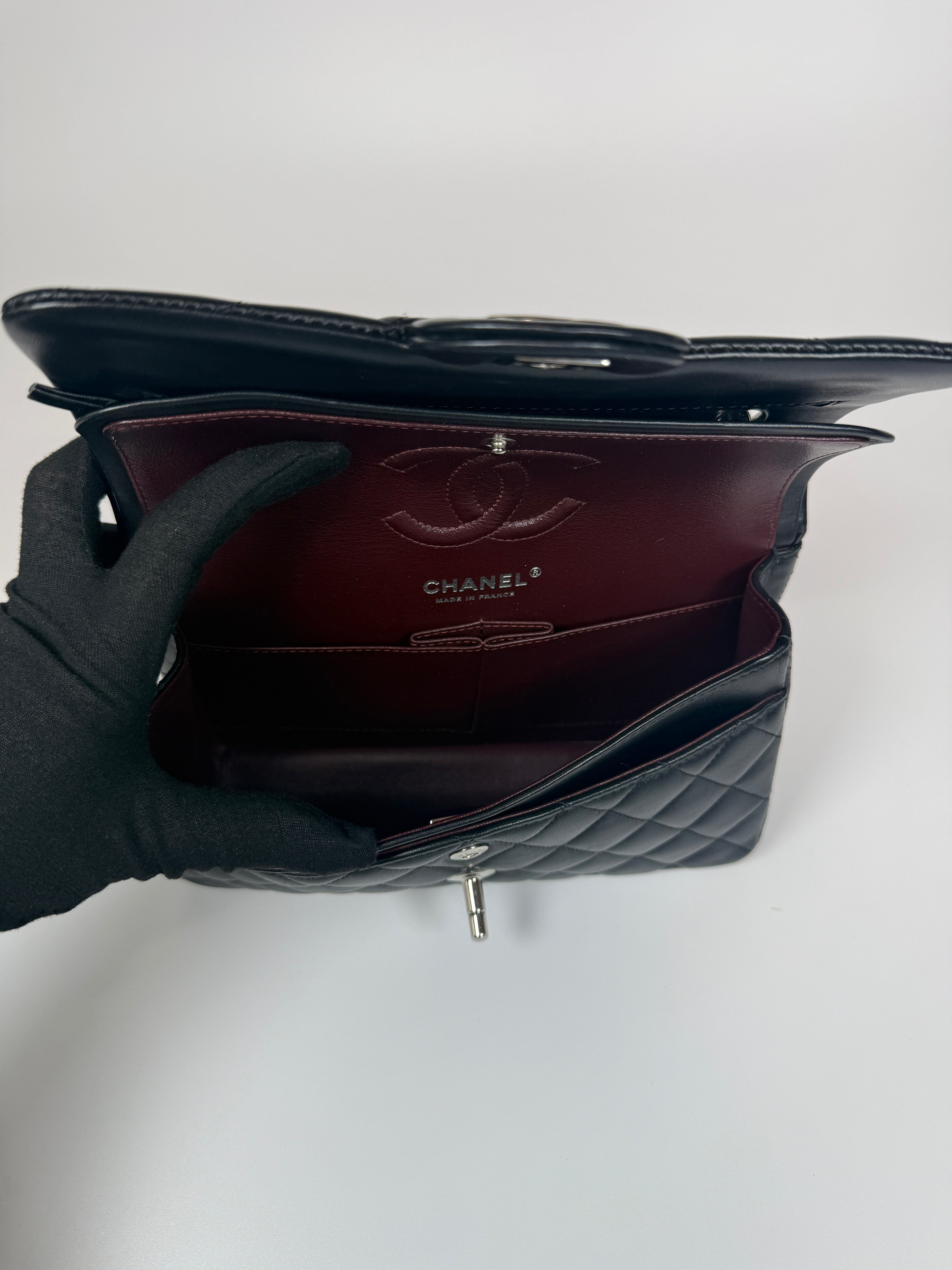 Authentic and preloved Chanel Small Classic Double Flap In Black Lambskin Leather With Silver hardware 100% Authenticity guarantee