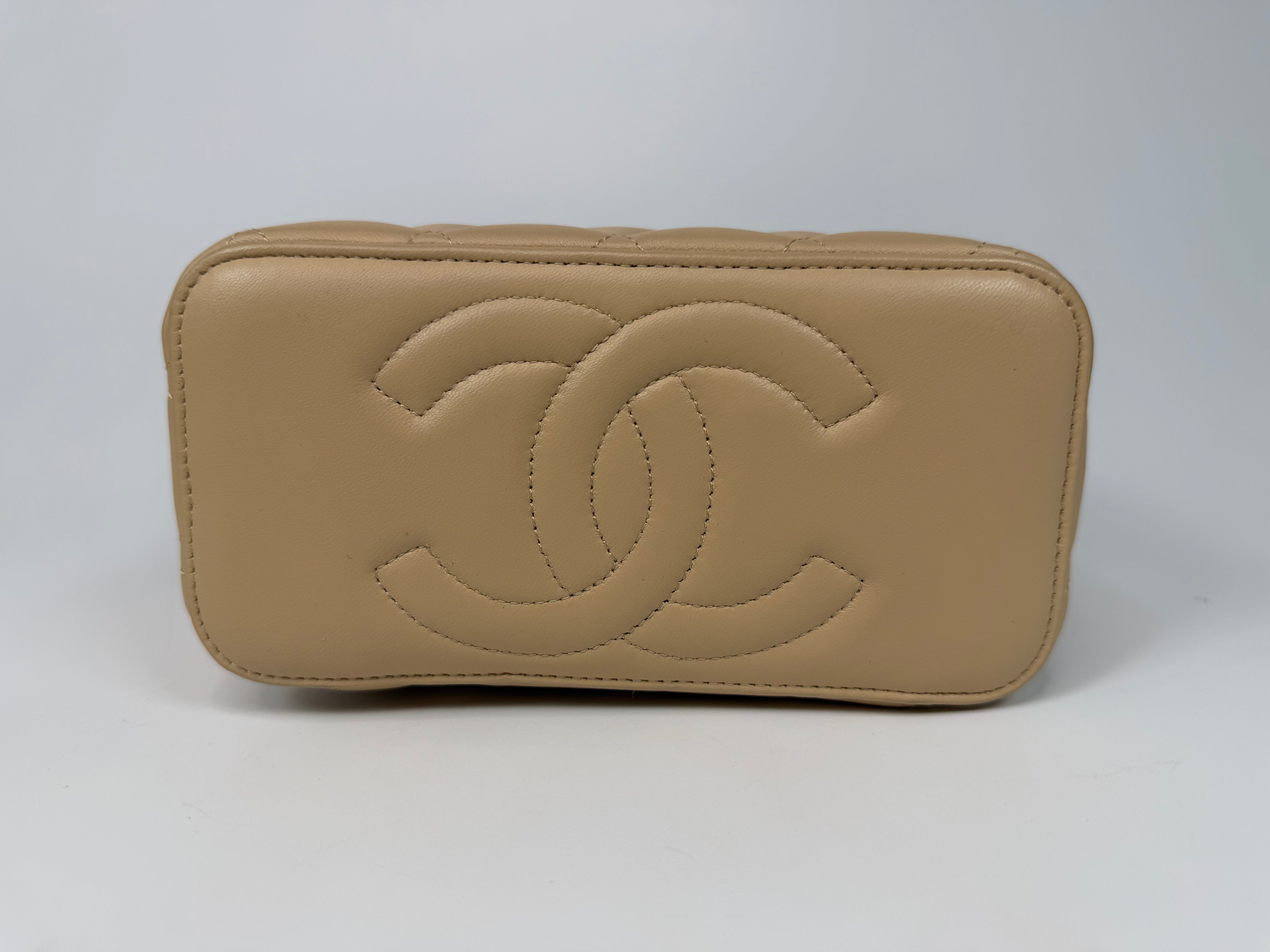 Chanel Mini Vanity Top Handle In Light Beige Lambskin Leather With Gold Hardware. Authentic and preloved in excellent condition. Insured next day delivery. Verified by Luxe Cheshire