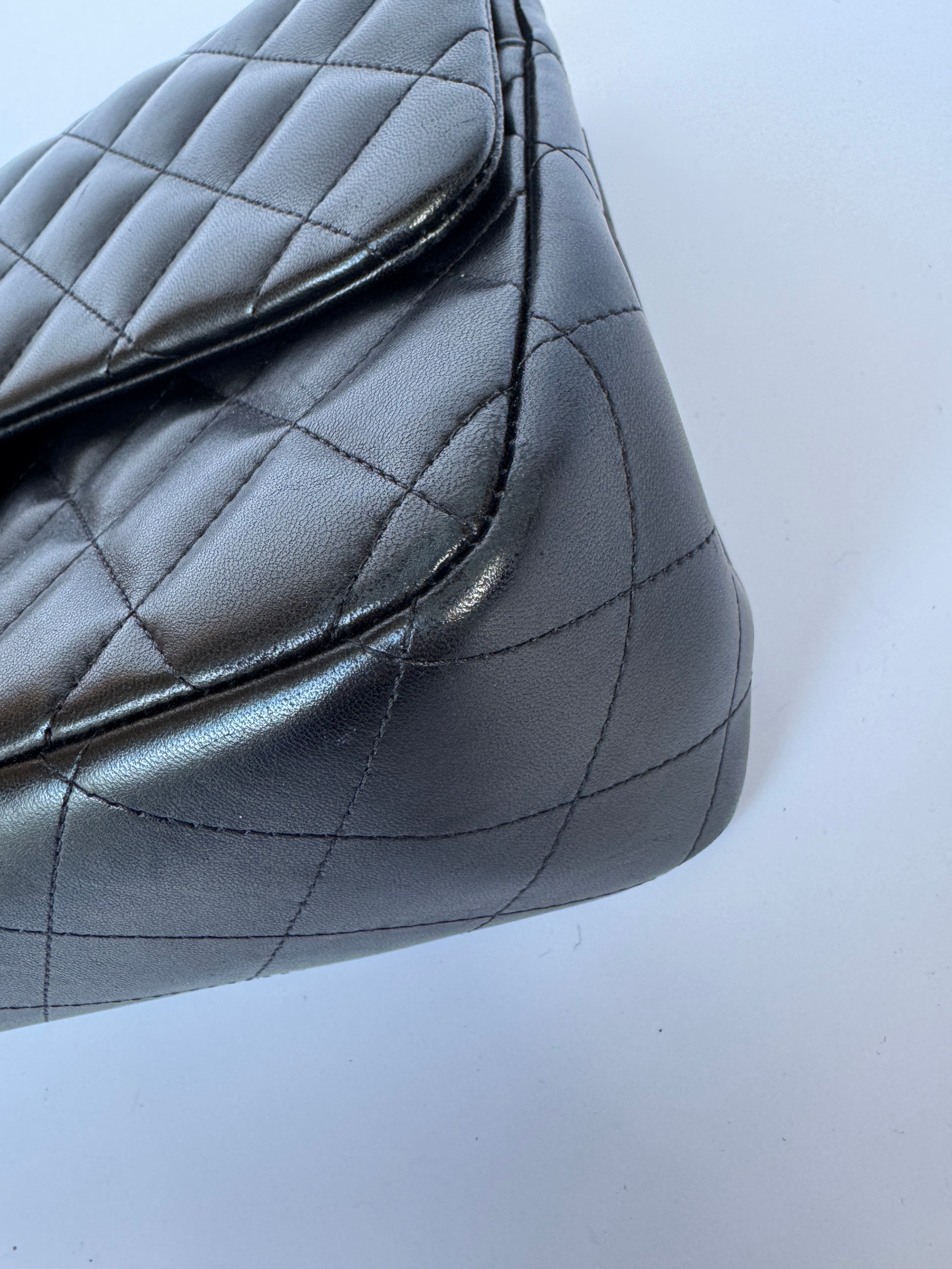 Authentic pre-loved Chanel Black Lambskin Leather Jumbo Classic Double Flap With Gold Hardware. 