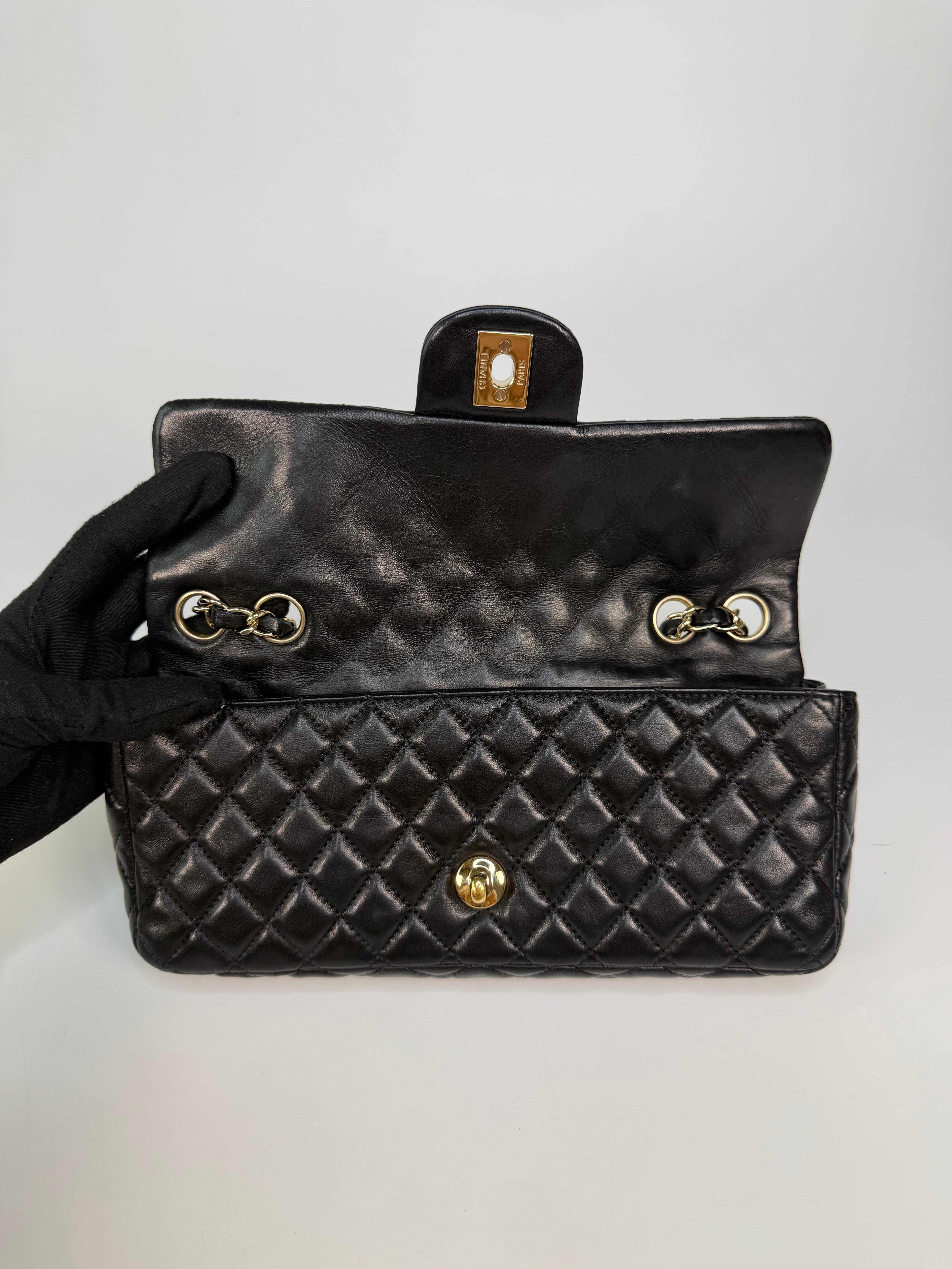 Chanel East West Charms Bag In Black Lambskin Leather With Gold Hardware. Authentic and preloved in excellent condition. 100% guarantee