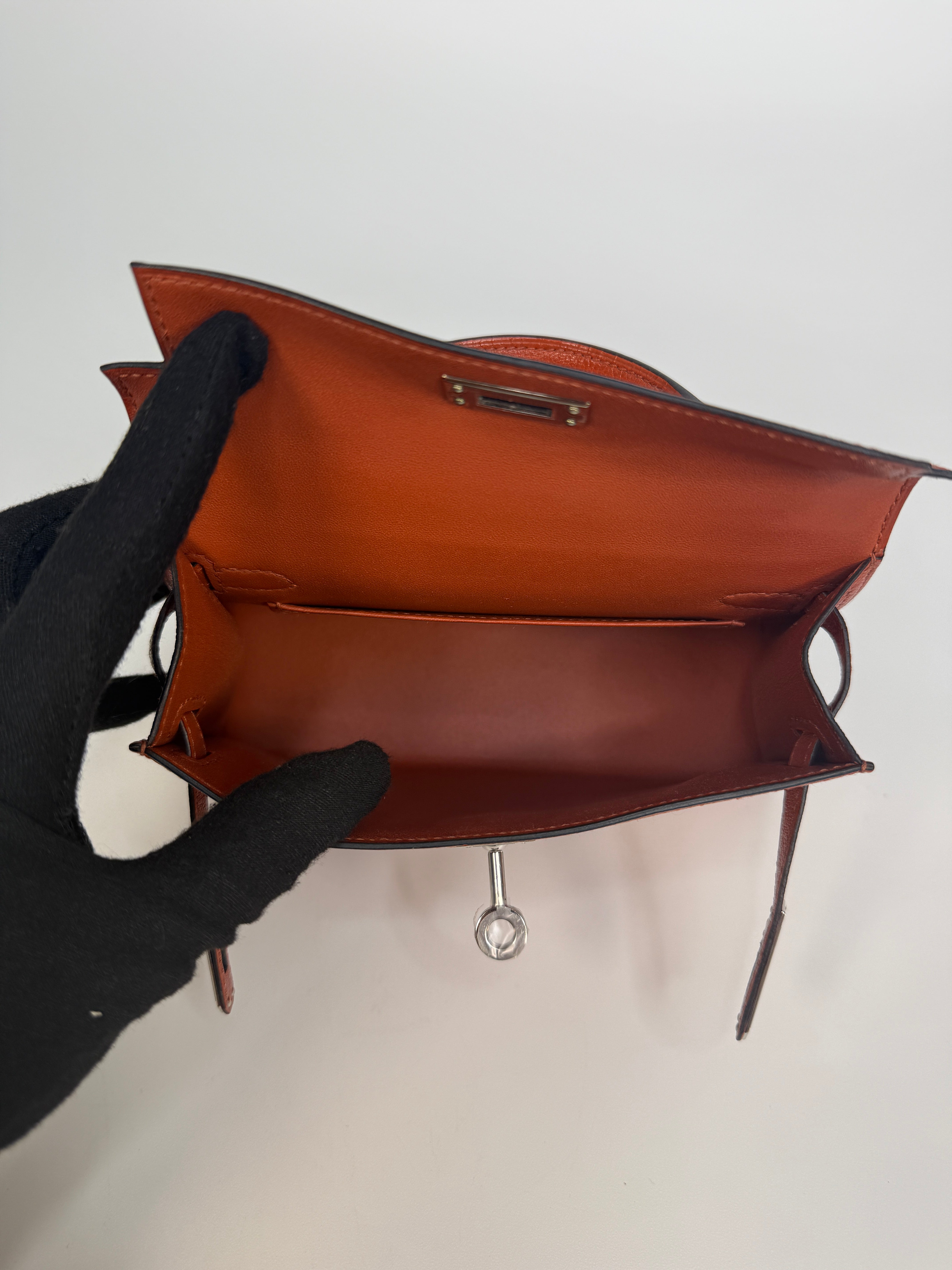 Hermès Mini Kelly In Cuivre Chèvre Mysore Leather With Palladium Hardware. Authentic and preloved in new and unused condition