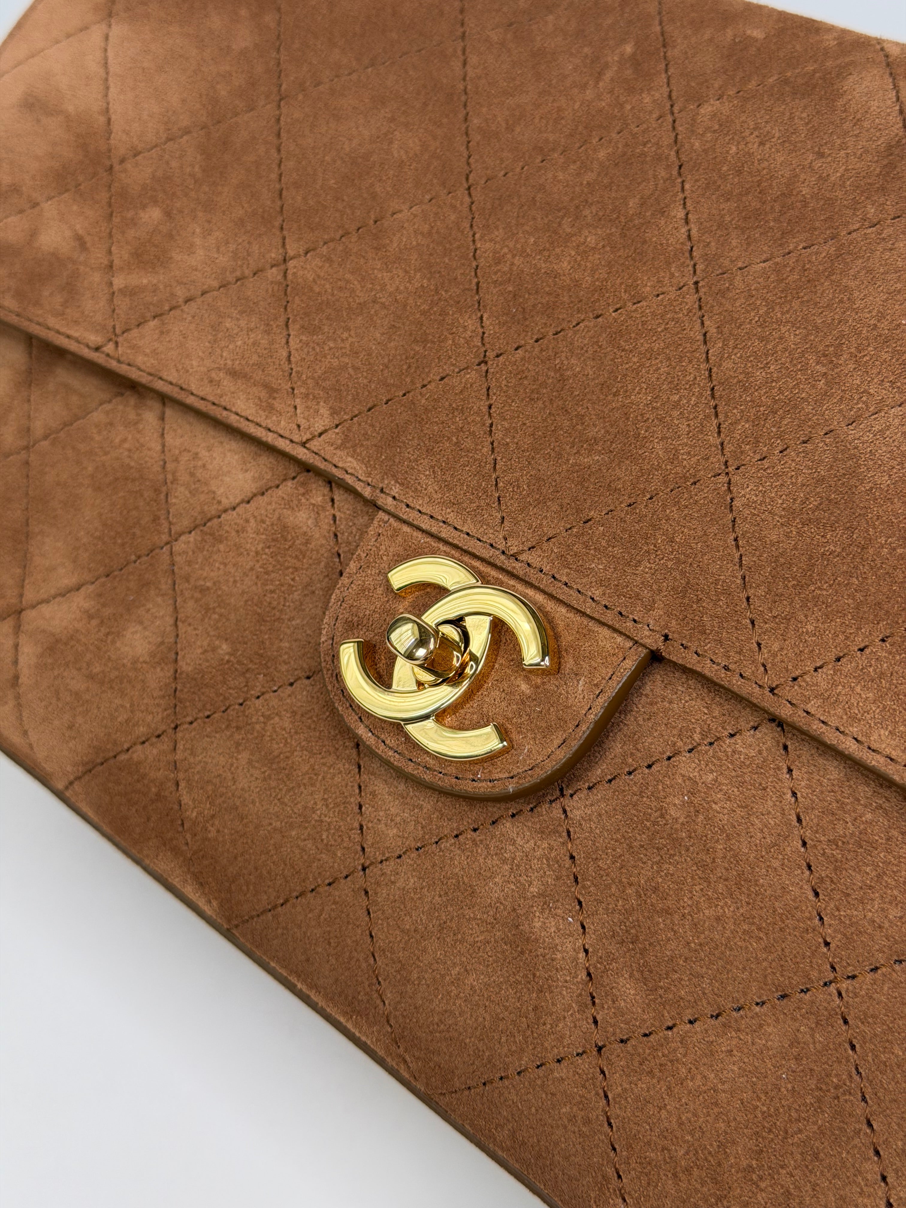 Chanel Maxi Flap In Tan Suede With Gold Hardware. Authentic and preloved in new and unused condition.