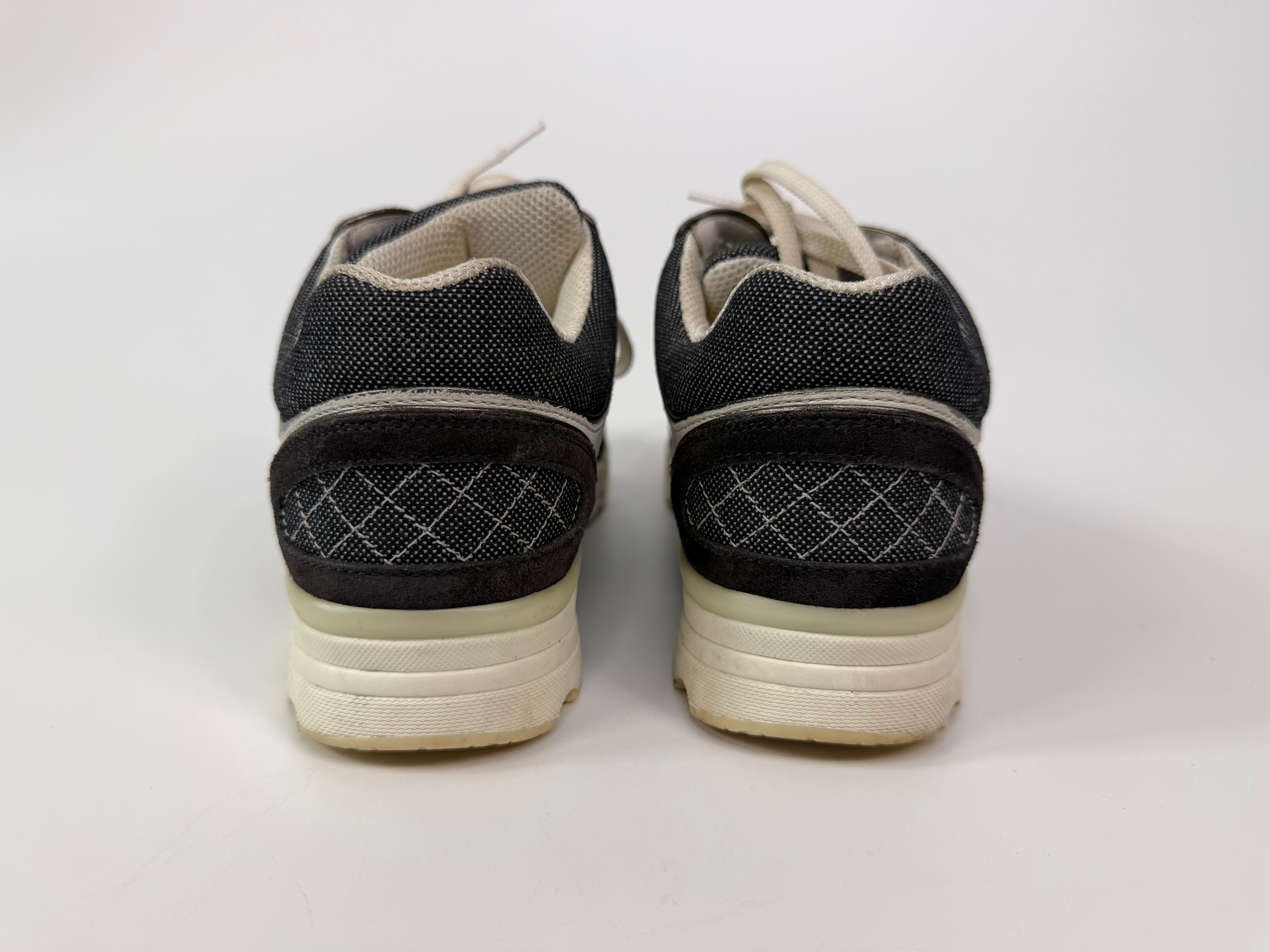 Chanel CC Sneakers In Dark Grey, White & Silver (Size 36.5/UK3.5). 100% authentic and preloved in excellent condition.