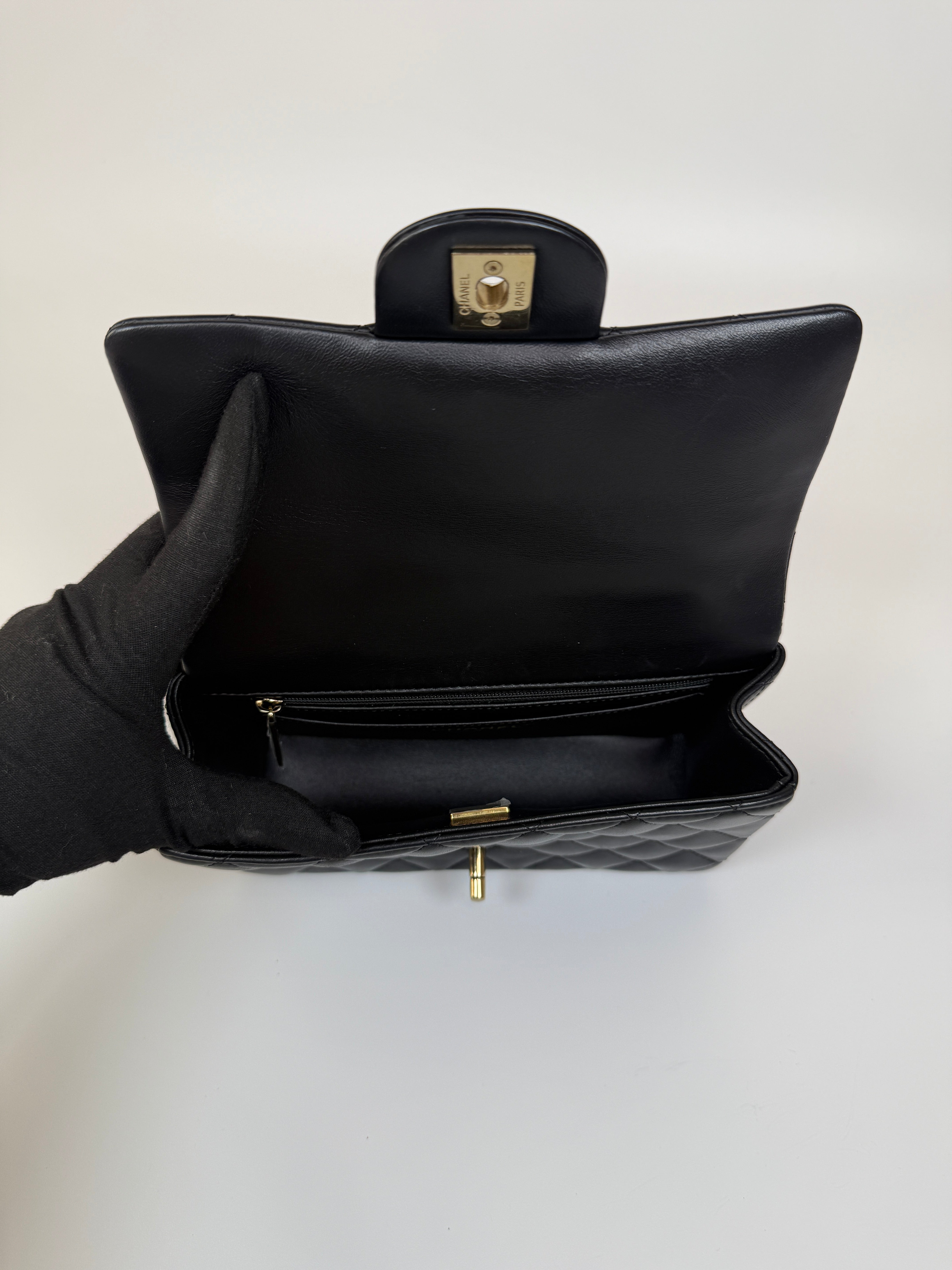 Authentic and preloved Chanel Mini Rectangle Top Handle Flap Bag In Black Lambskin With Gold hardware. Excellent Condition. 100% Authenticity guarantee 