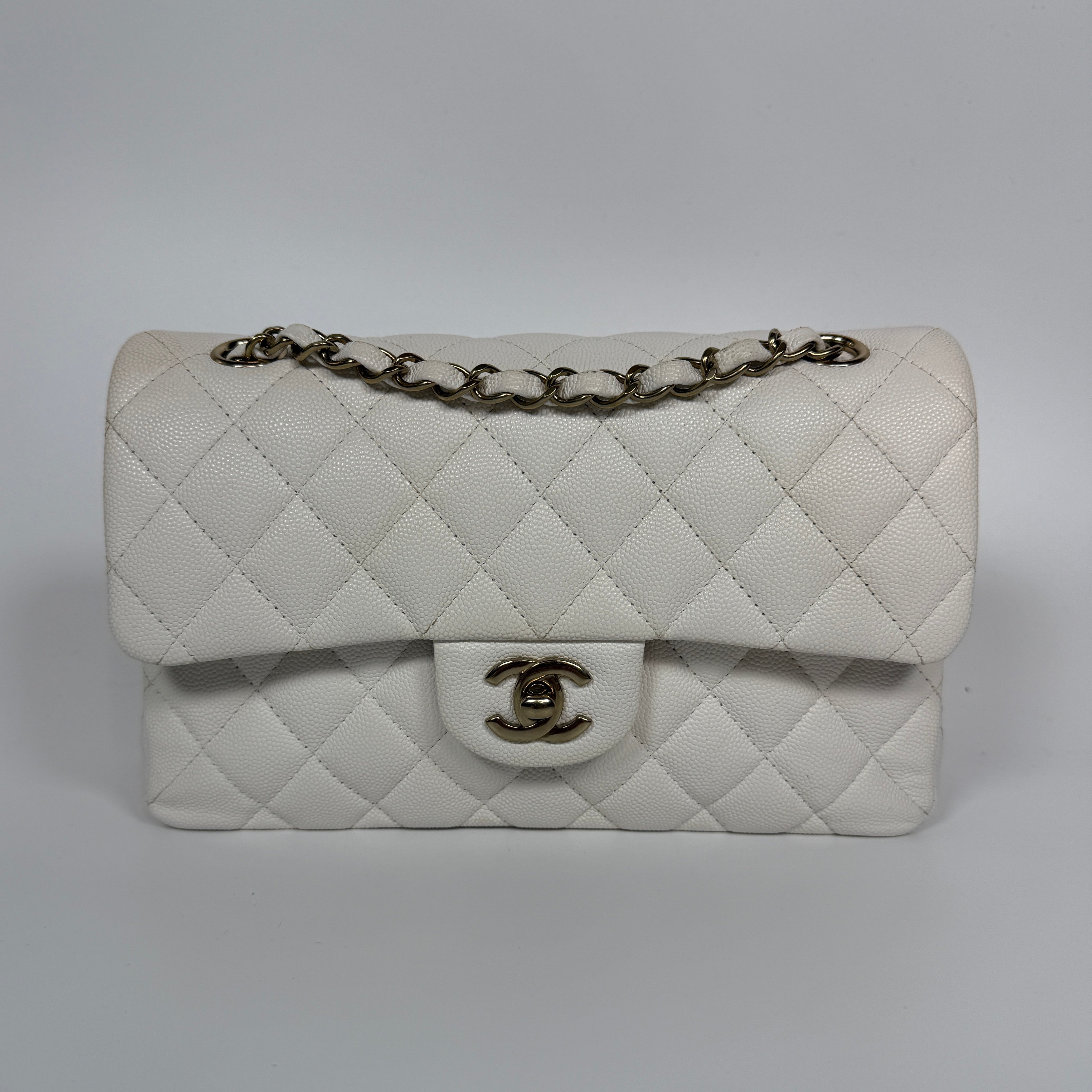 Authentic and preloved Chanel Small Classic Double Flap In White Caviar Leather With pale gold hardware. Very Good Condition. 100% Authenticity guarantee 