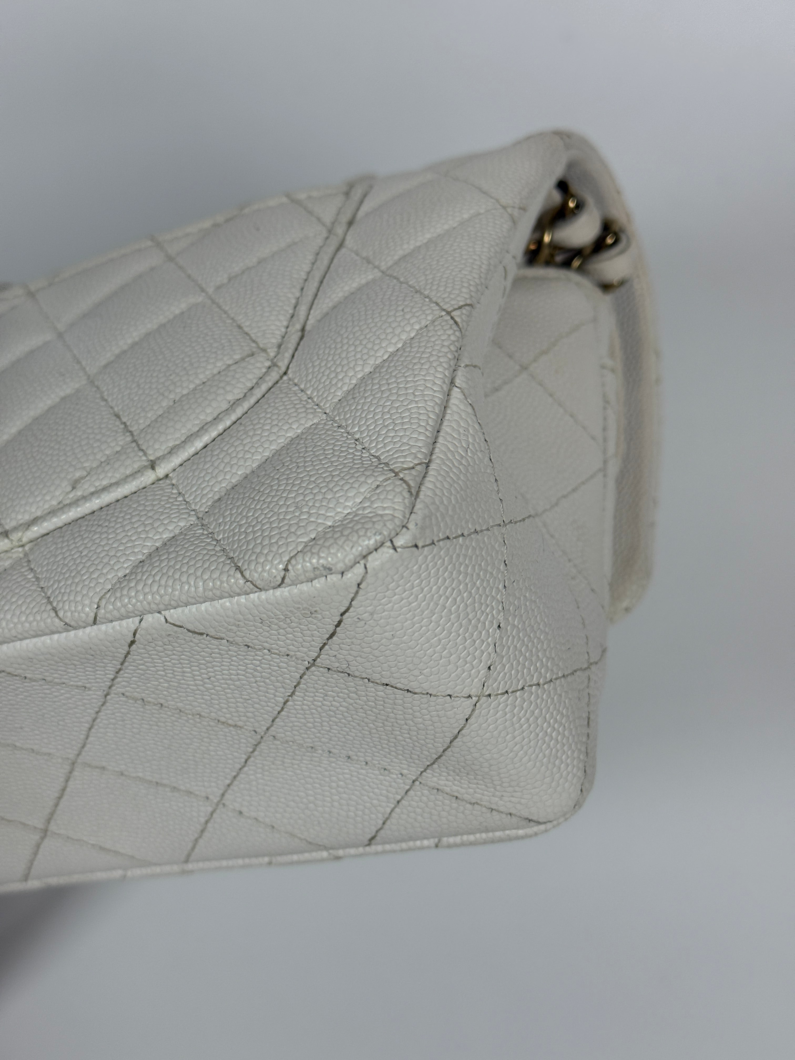 Authentic and preloved Chanel Small Classic Double Flap In White Caviar Leather With pale gold hardware. Very Good Condition. 100% Authenticity guarantee 