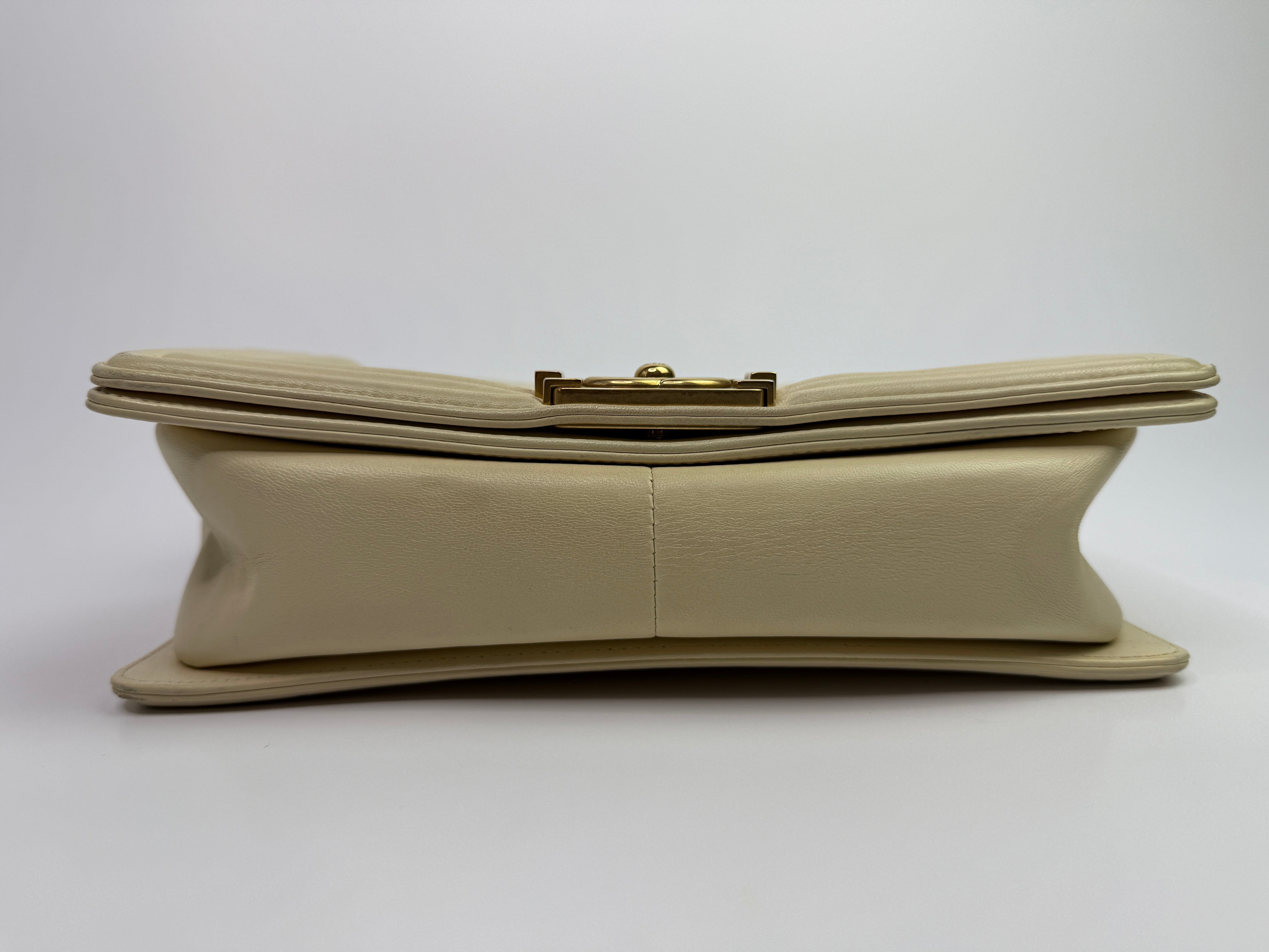 Authentic pre-loved Chanel Boy Bag Medium In Cream Lambskin With Gold Hardware. 