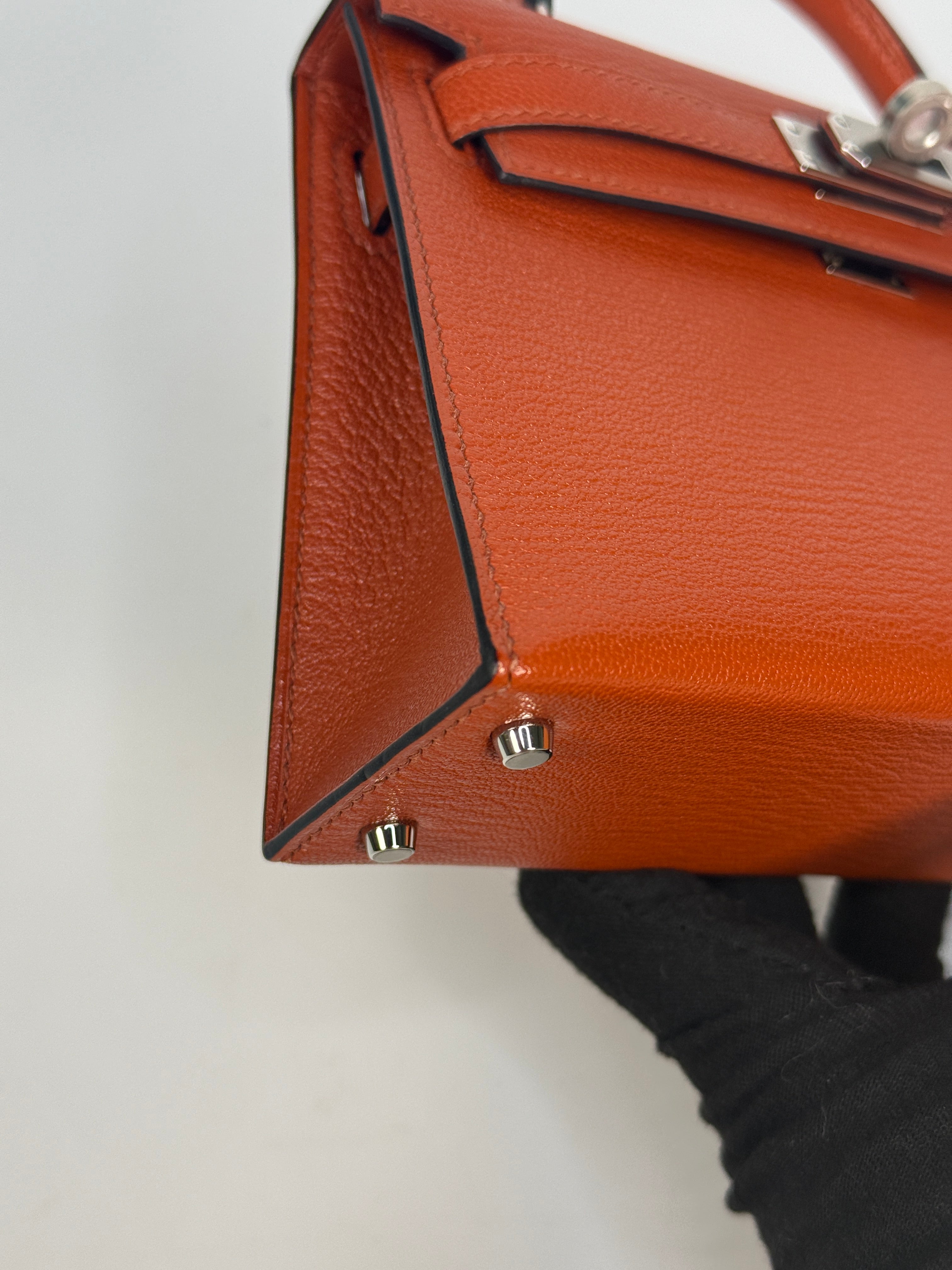 Hermès Mini Kelly In Cuivre Chèvre Mysore Leather With Palladium Hardware. Authentic and preloved in new and unused condition