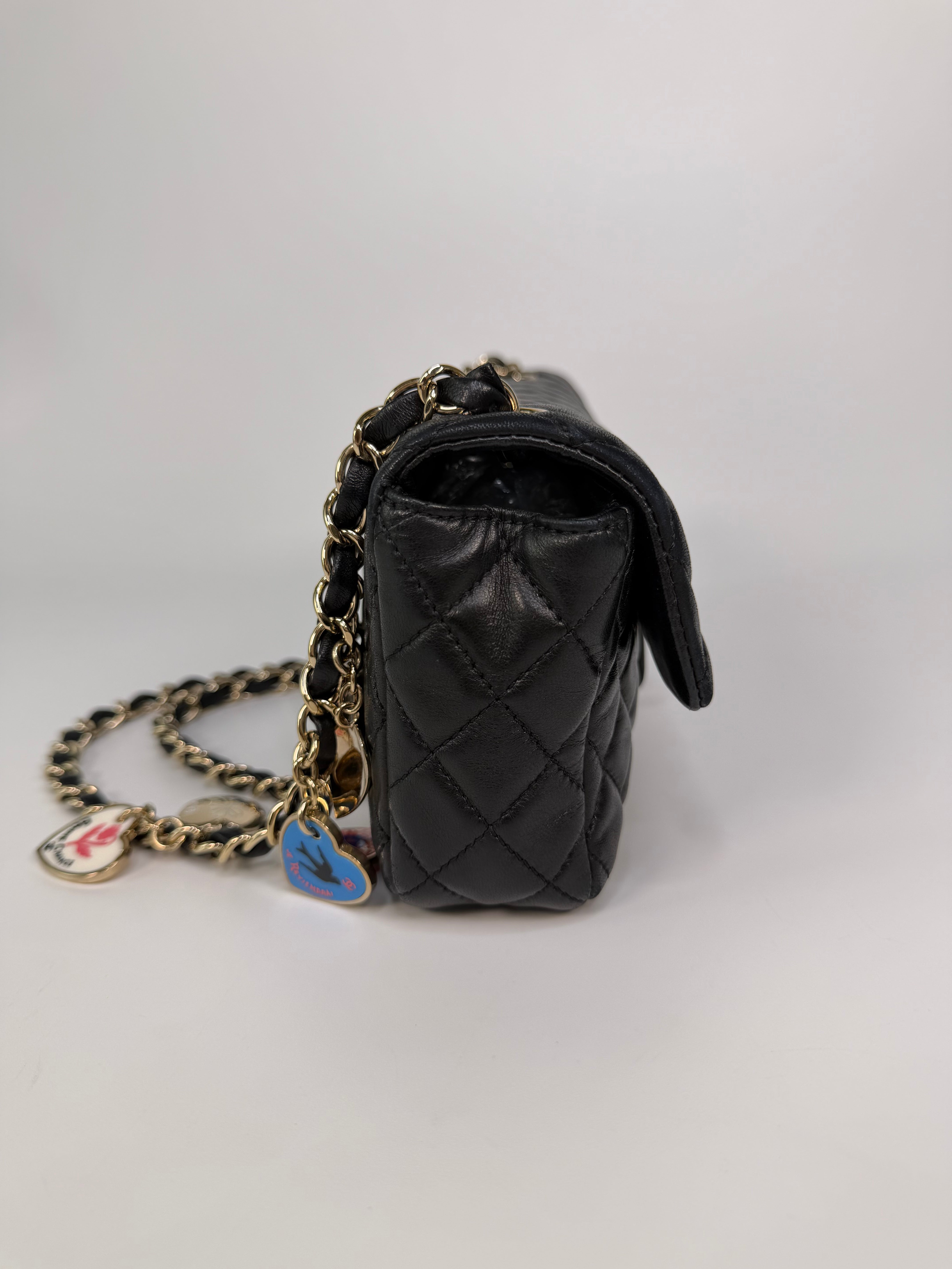 Chanel East West Charms Bag In Black Lambskin Leather With Gold Hardware. Authentic and preloved in excellent condition. 100% guarantee
