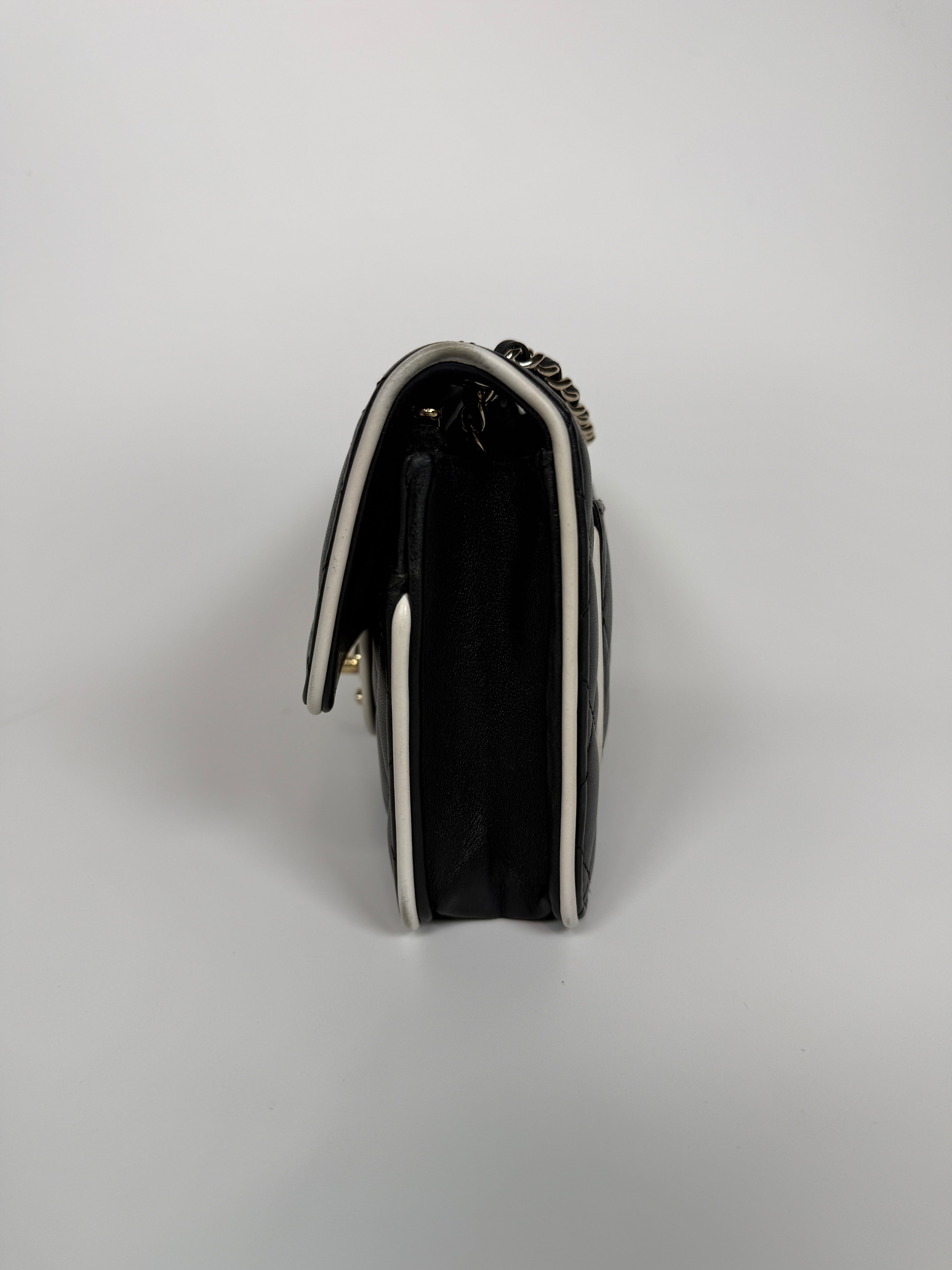 Authentic and preloved Chanel Wallet On Chain In Black & White Lambskin Leather With Pale Gold Hardware. Very Good Condition. 100% Authenticity Guarantee 