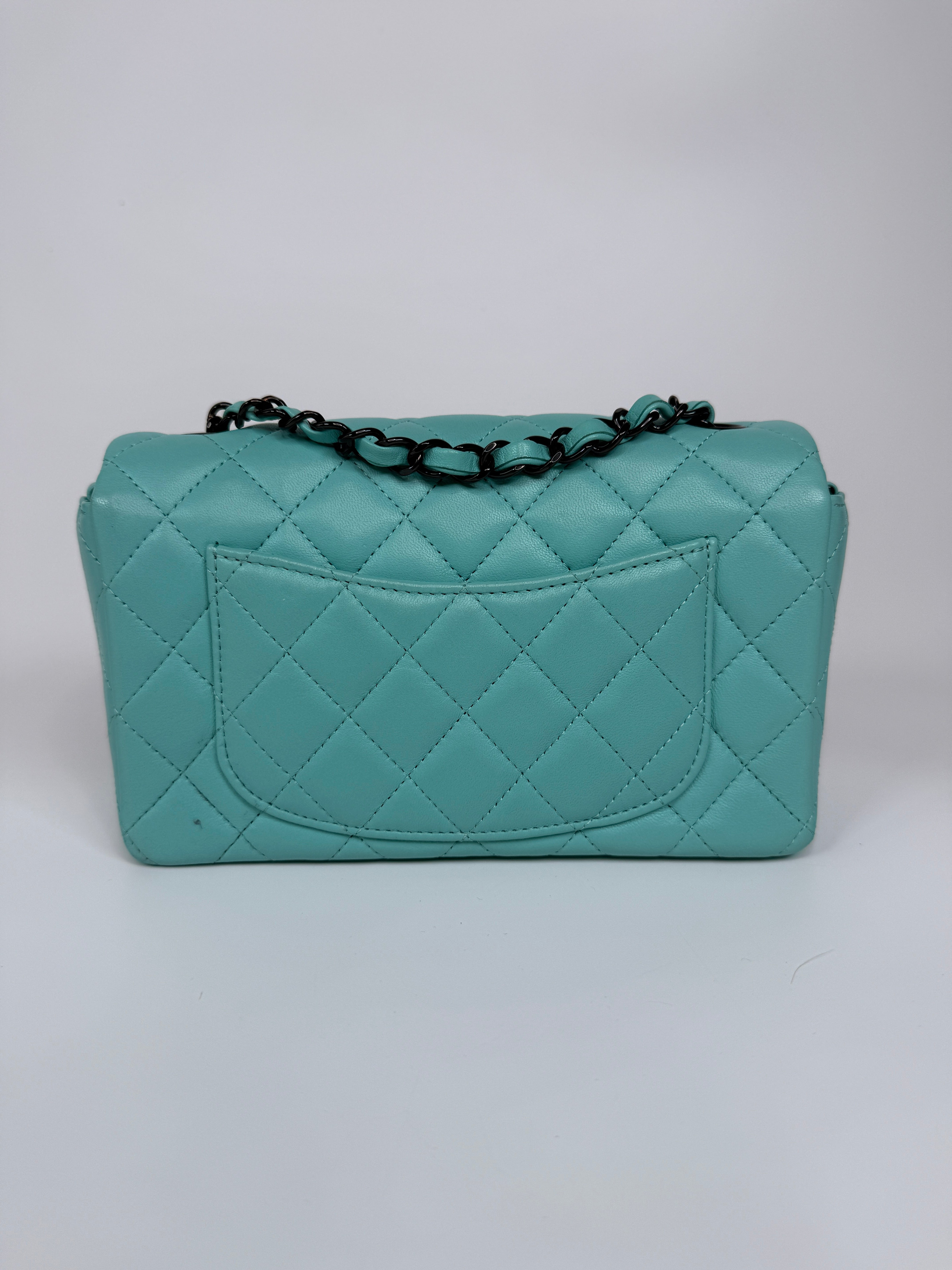 Authentic and preloved Chanel Mini Rectangle Flap Bag In Turquoise Lambskin Leather With Gunmetal Hardware In Excellent condition. Verified by Luxe Cheshire. 100% Authenticity Guarantee. 