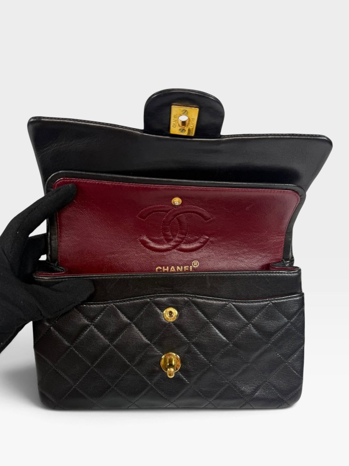 Chanel Vintage Small Classic Double Flap In Black Lambskin Leather 24Kt Hardware. Authentic and preloved in excellent condition. 100% guarantee