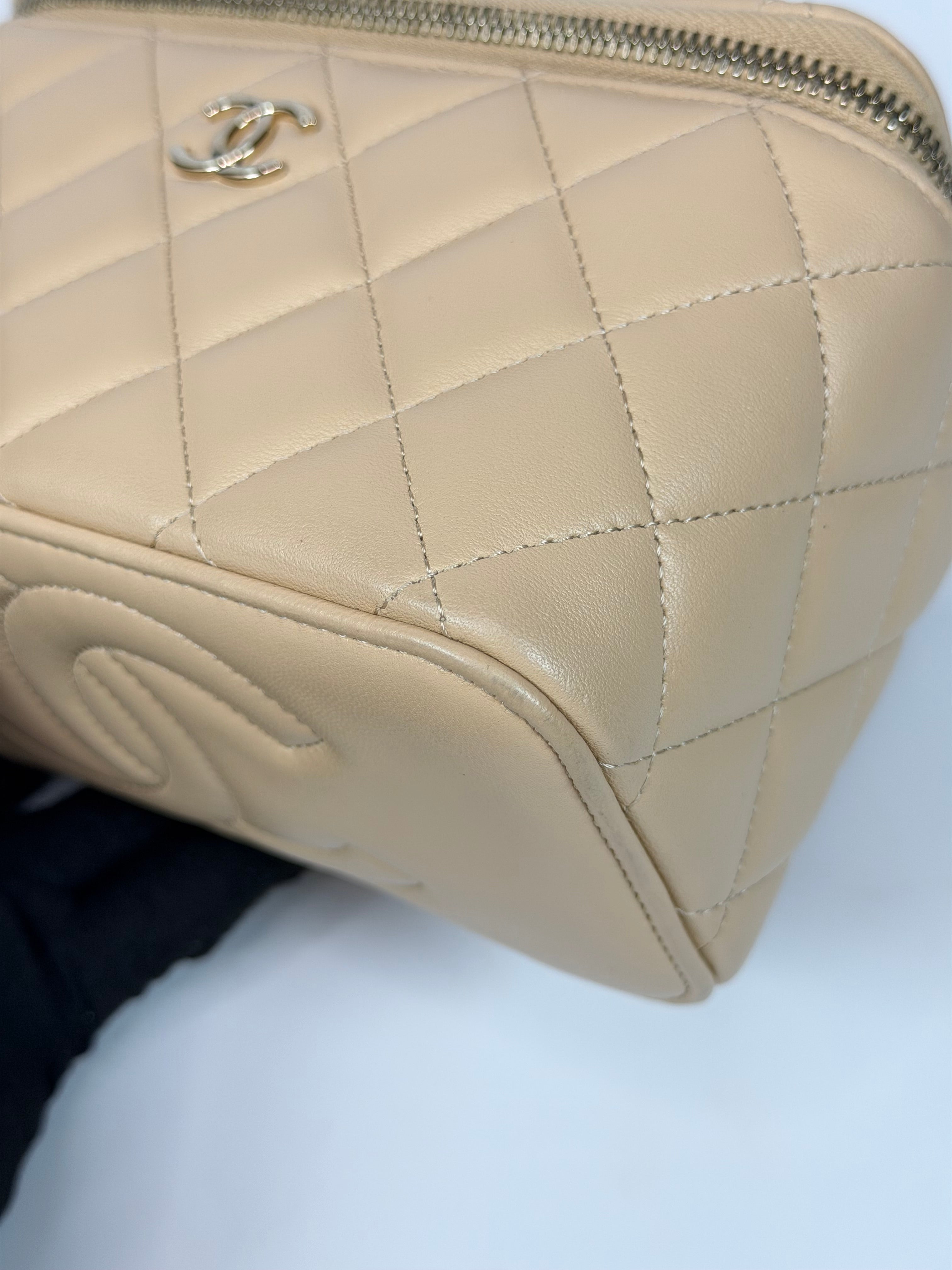 Chanel Mini Vanity Top Handle In Light Beige Lambskin Leather With Gold Hardware. Authentic and preloved in excellent condition. Insured next day delivery. Verified by Luxe Cheshire
