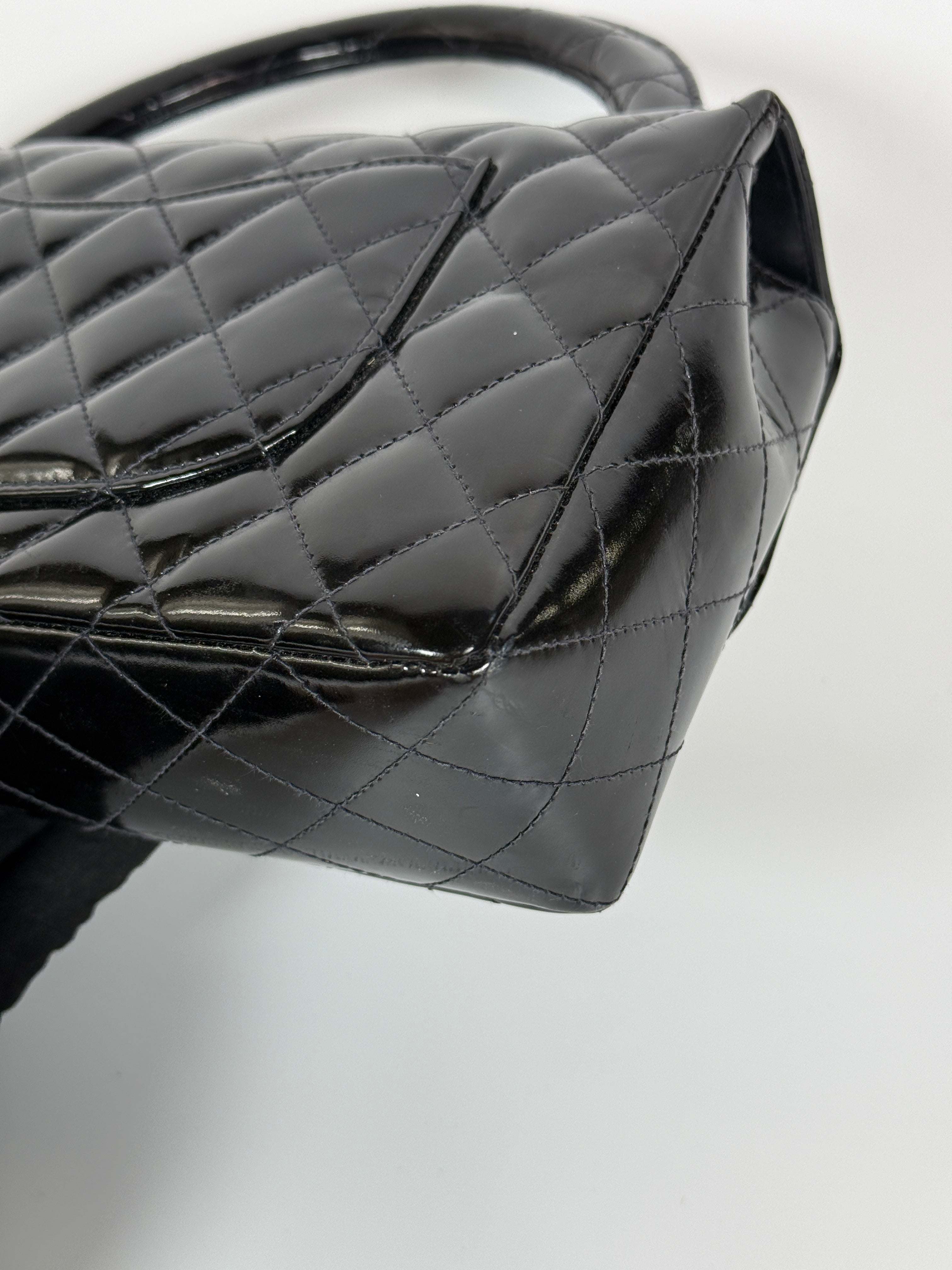 Authentic and preloved Chanel Vintage Kelly Top Handle Bag In Black Patent Leather With 24kt Gold Hardware. Very Good condition. 100% Authenticity guarantee 