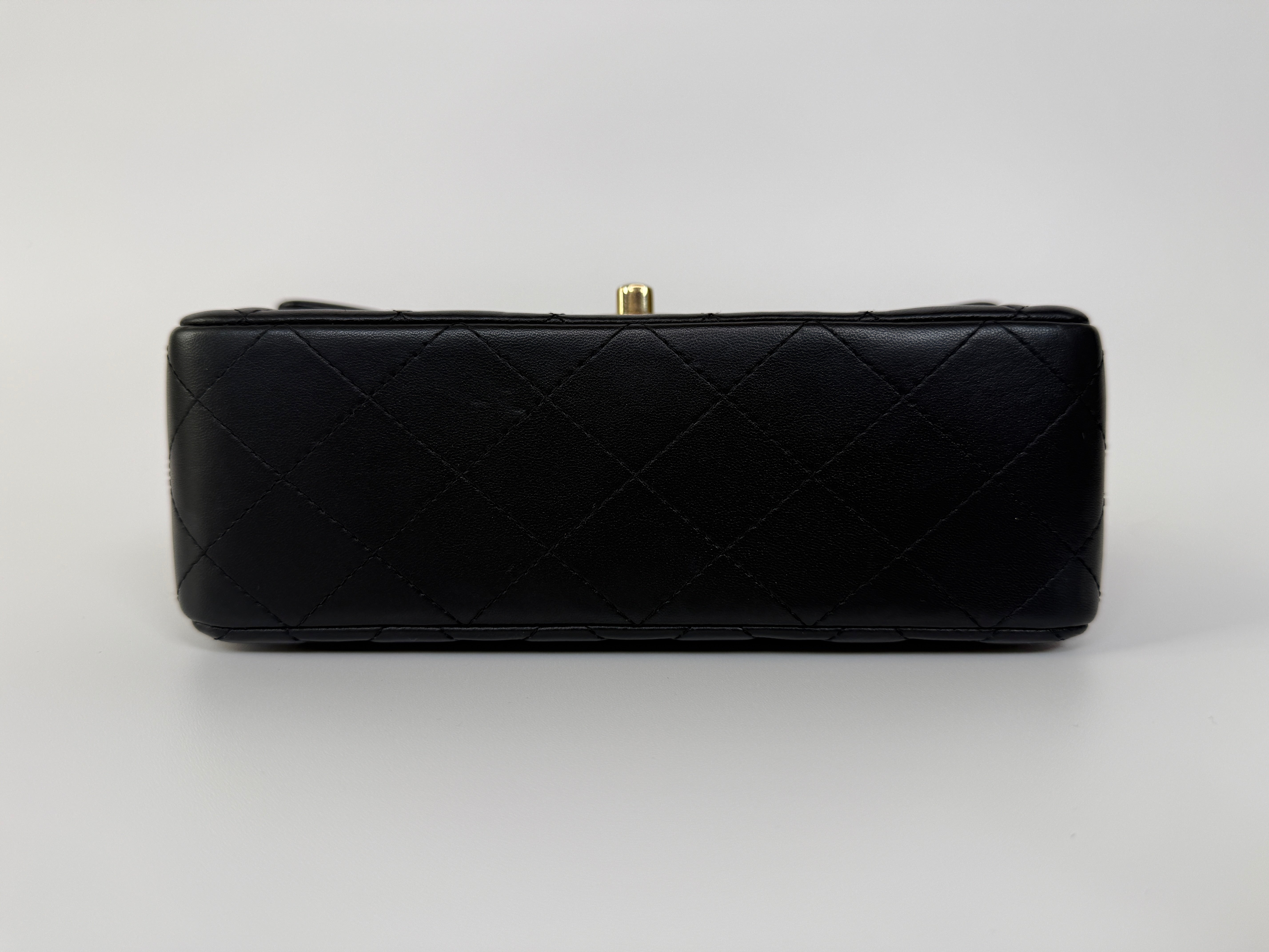 Authentic and preloved Chanel Mini Rectangle Top Handle Flap Bag In Black Lambskin With Gold hardware. Excellent Condition. 100% Authenticity guarantee 