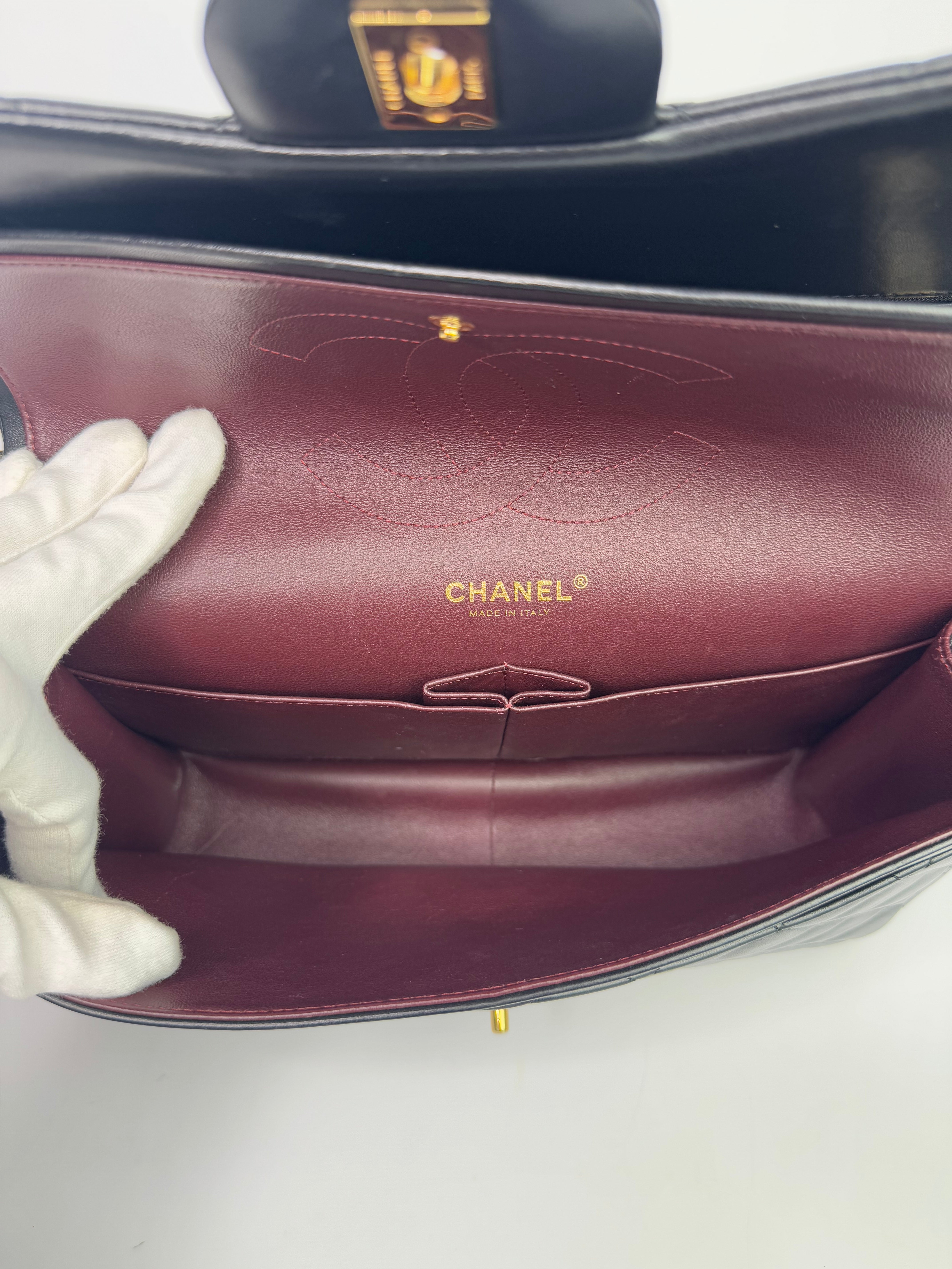 Authentic pre-loved Chanel Black Lambskin Leather Jumbo Classic Double Flap With Gold Hardware. 