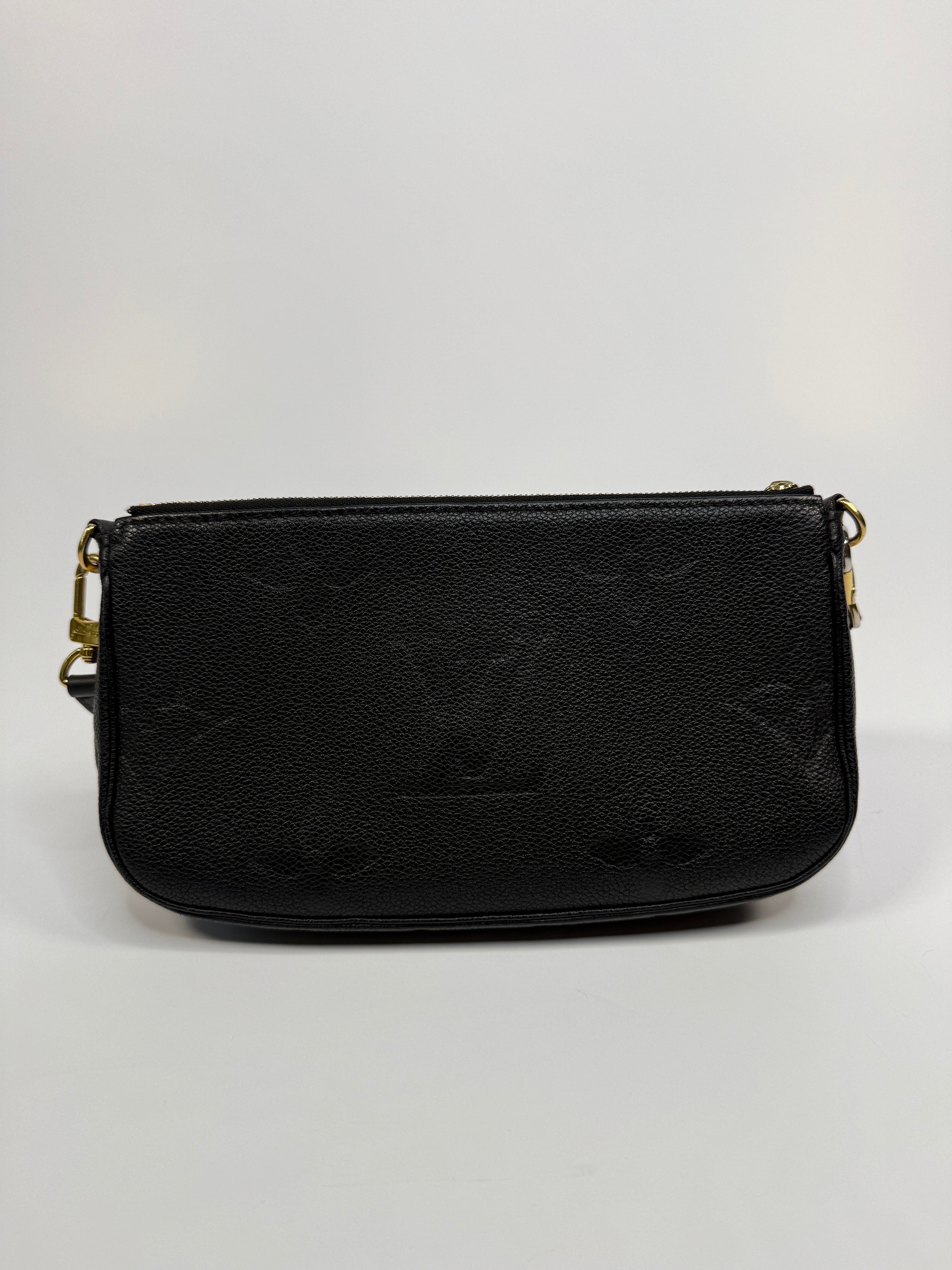 Black leather wallet with gold zipper on a white background