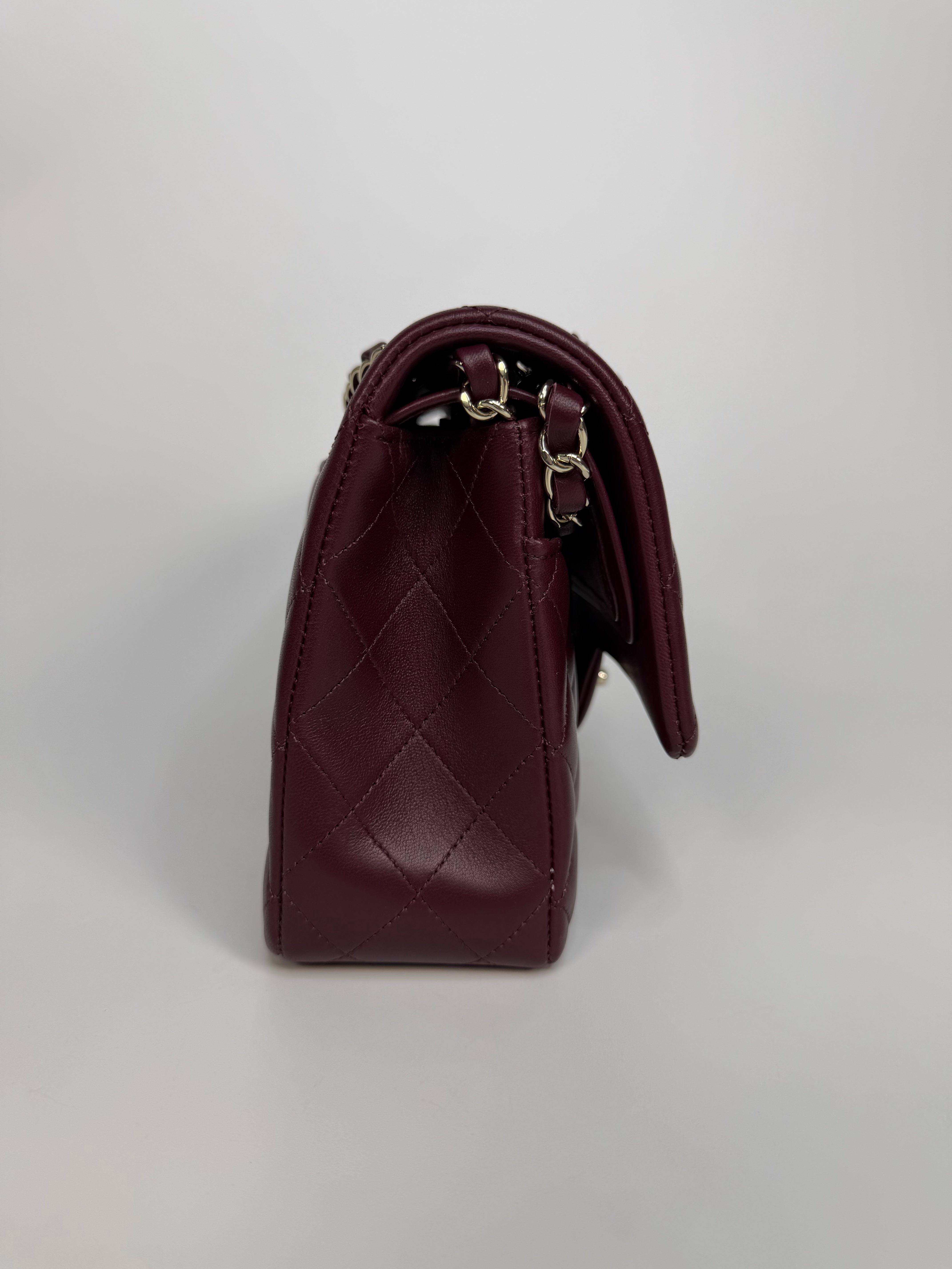 Chanel Medium Classic Double Flap Burgundy Lambskin Leather With Pale Gold Hardware. Authentic and preloved in excellent condition with 100% authenticity guarantee.