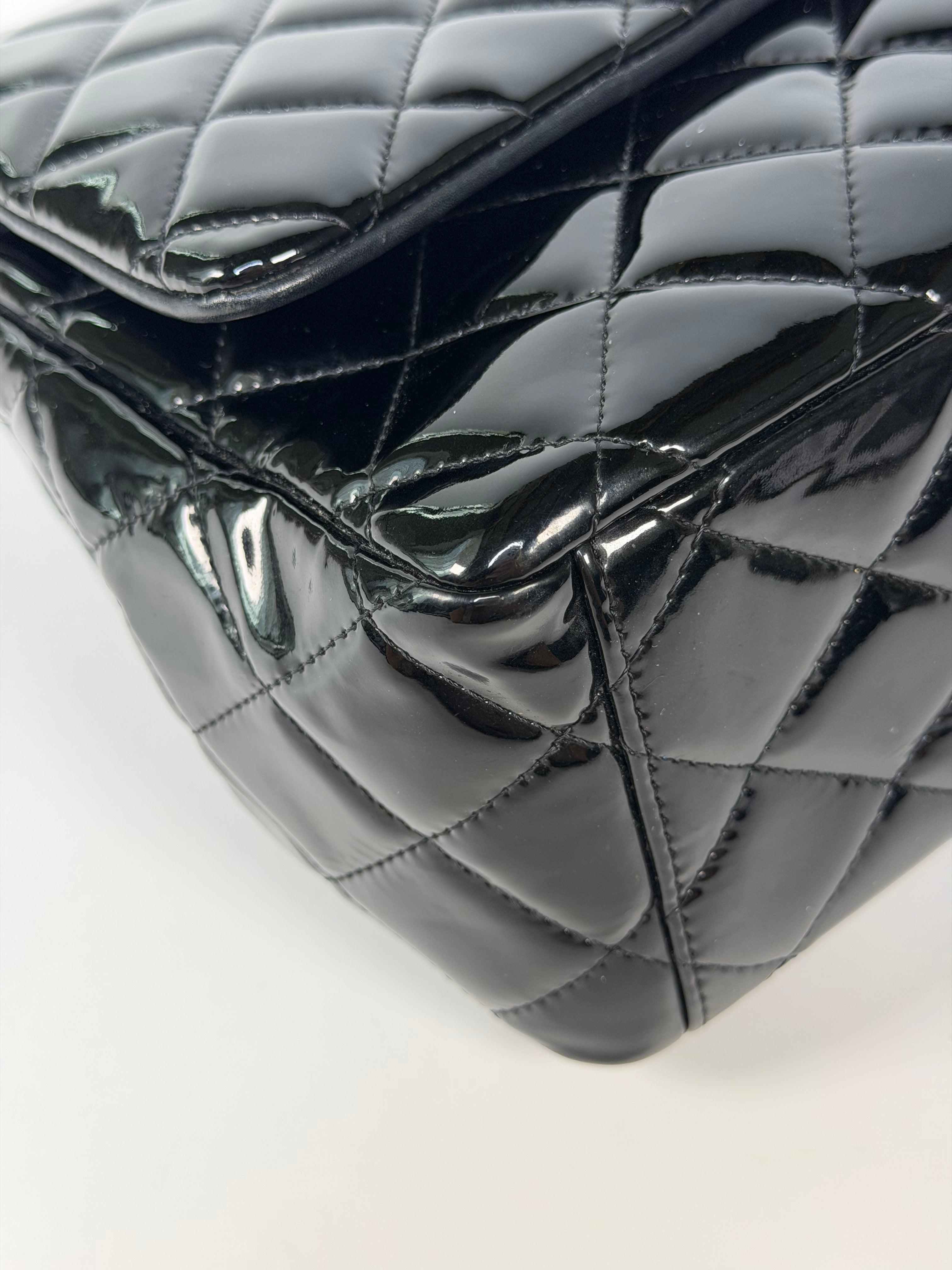 Chanel Maxi Classic Double Flap In Black Patent Leather With Silver Hardware. 100% authentic and preloved in excellent condition.