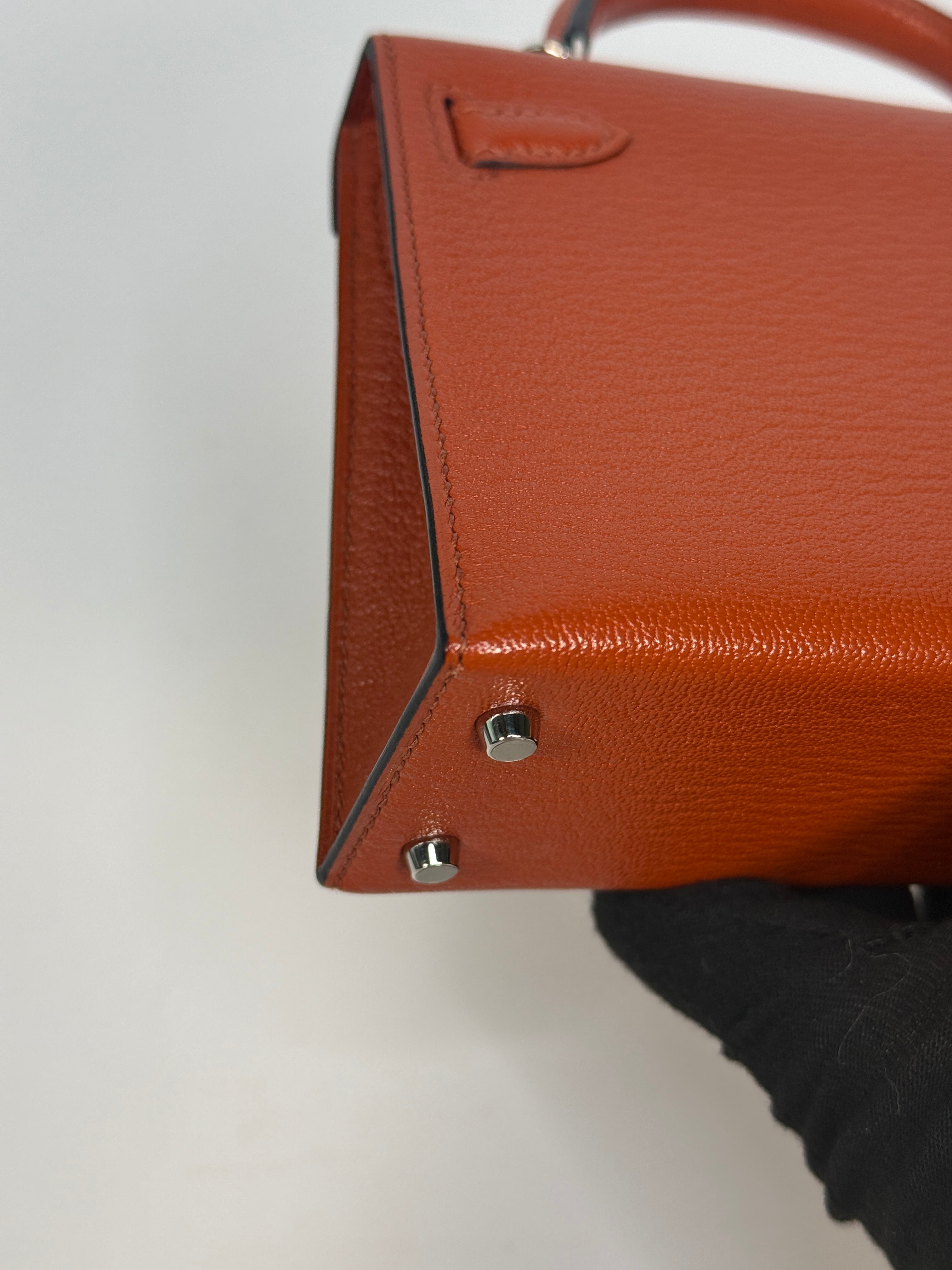 Hermès Mini Kelly In Cuivre Chèvre Mysore Leather With Palladium Hardware. Authentic and preloved in new and unused condition