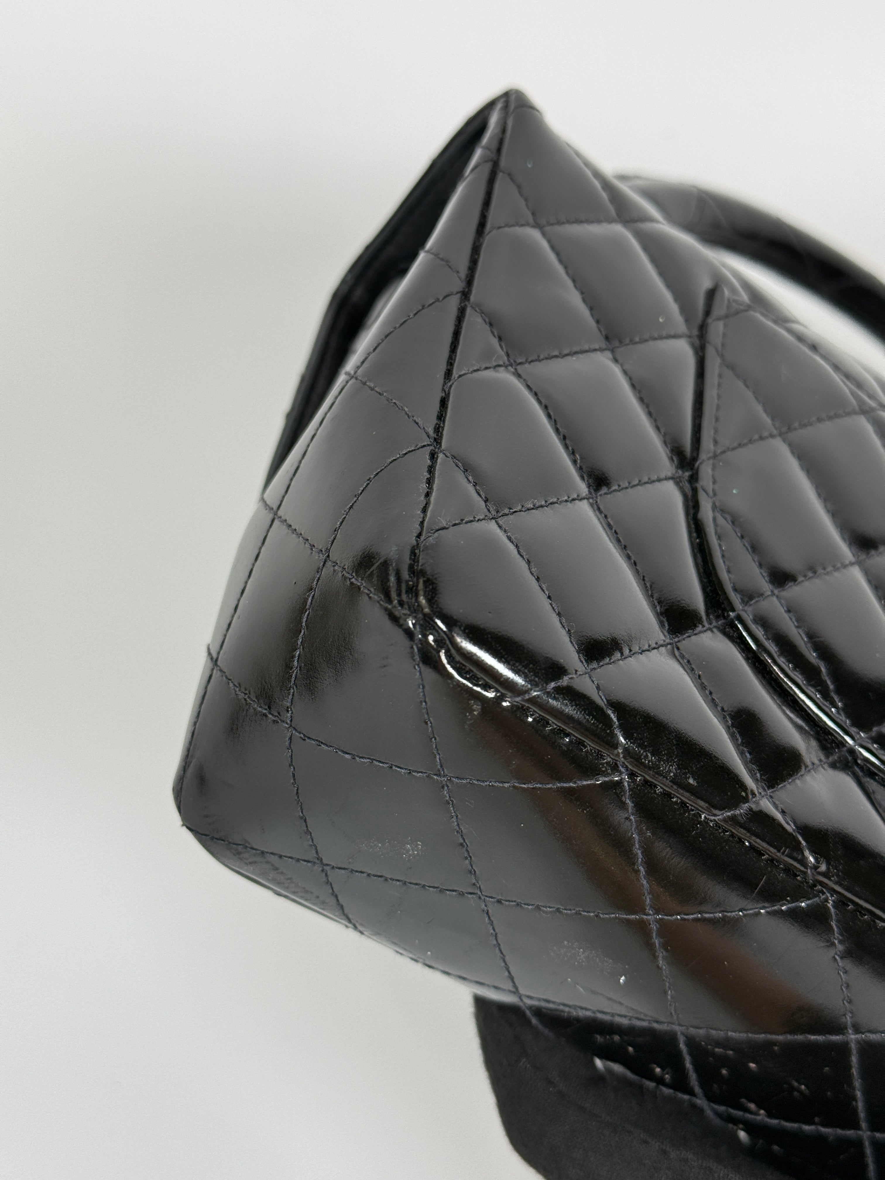 Authentic and preloved Chanel Vintage Kelly Top Handle Bag In Black Patent Leather With 24kt Gold Hardware. Very Good condition. 100% Authenticity guarantee 