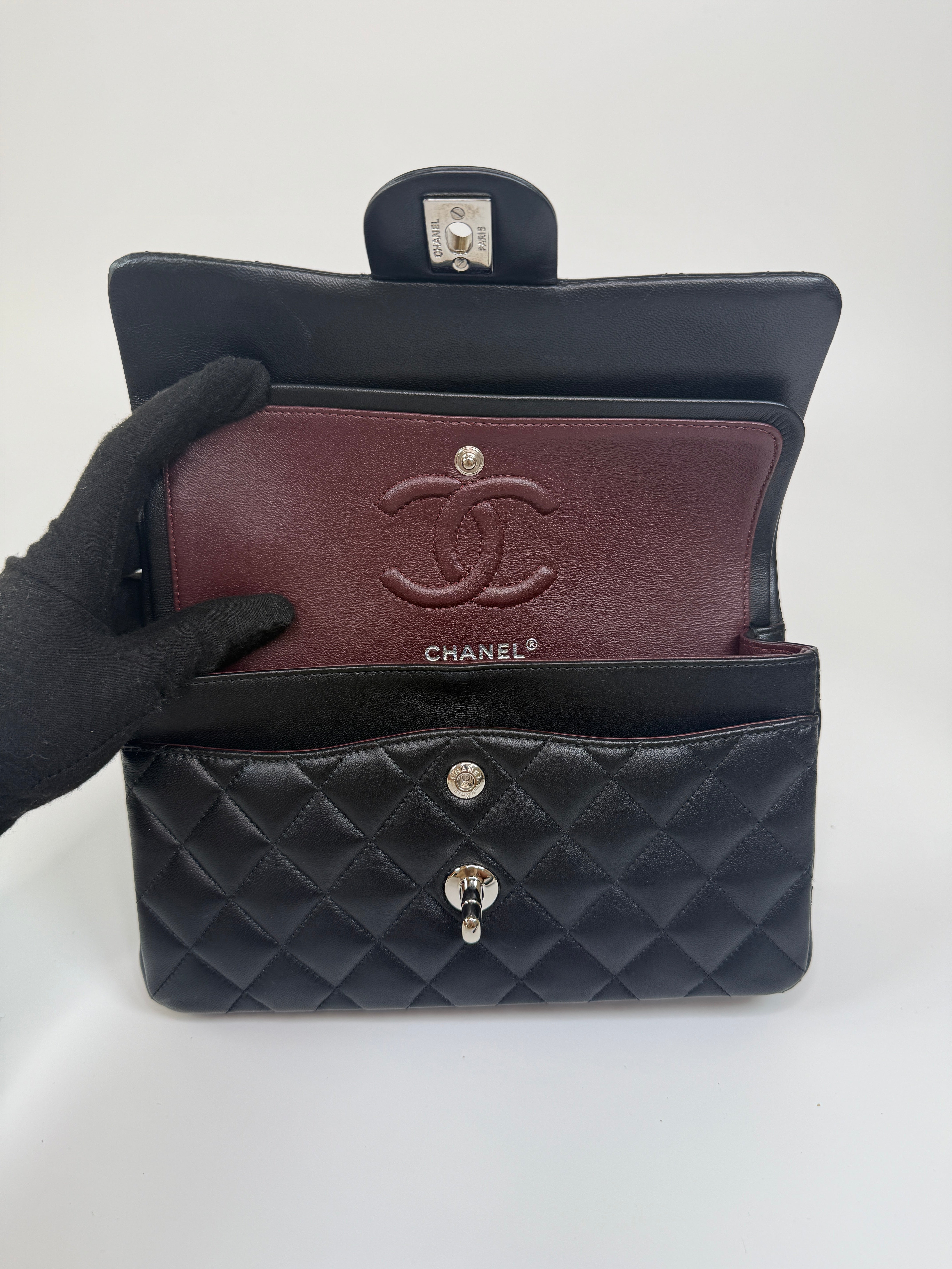 Chanel Small Classic Double Flap In Black Lambskin Leather With Silver Hardware Authentic and preloved in excellent condition. 100% Authenticity guarantee