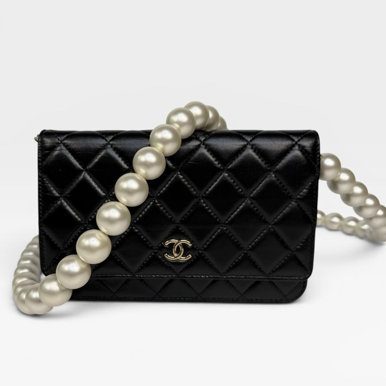 Chanel Pearl Wallet On Chain In Black Lambskin Leather With Gold Hardware. Authentic and preloved in very good condition.