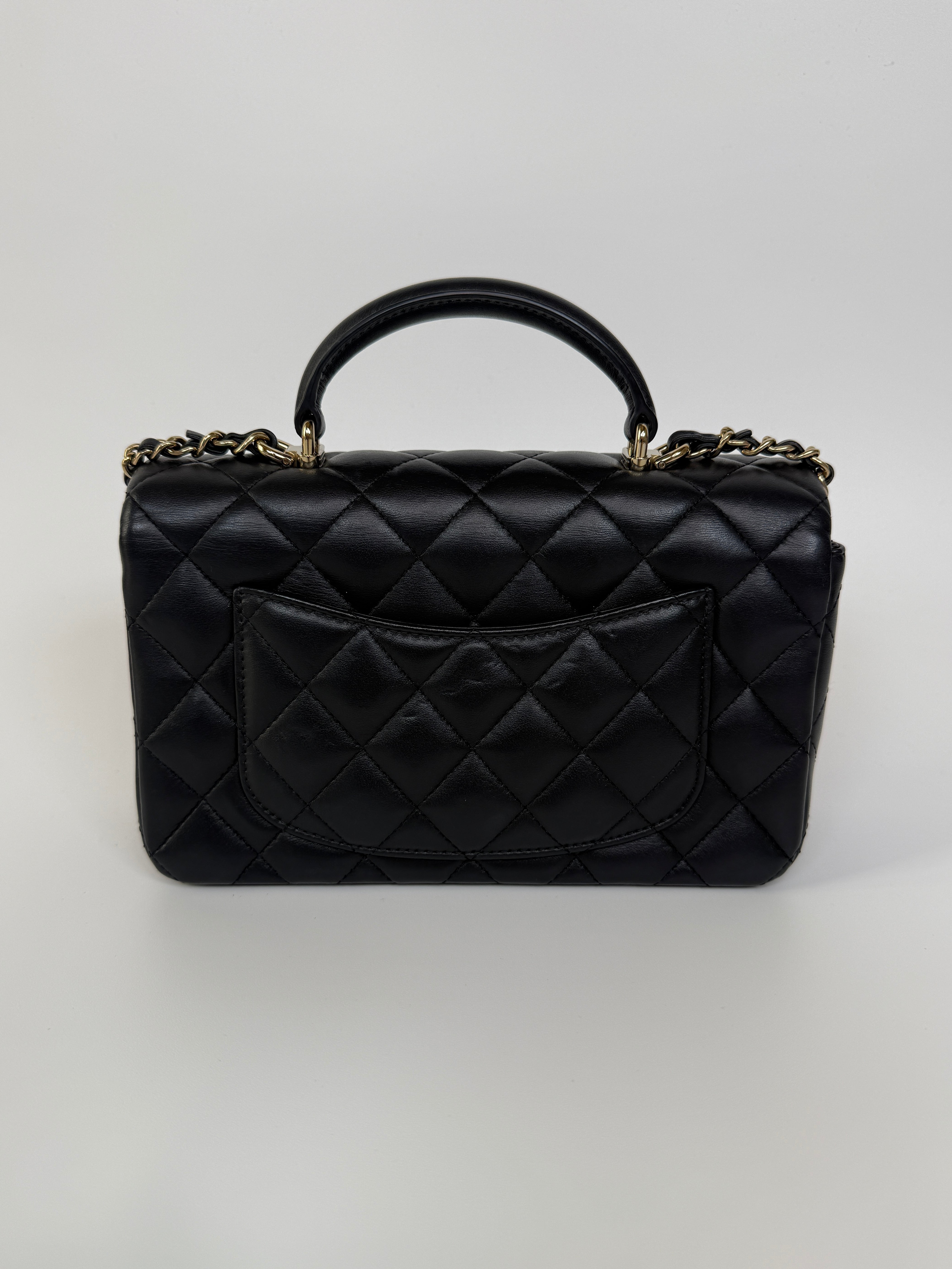 Authentic and preloved Chanel Mini Rectangle Top Handle Flap Bag In Black Lambskin With Gold hardware. Excellent Condition. 100% Authenticity guarantee 