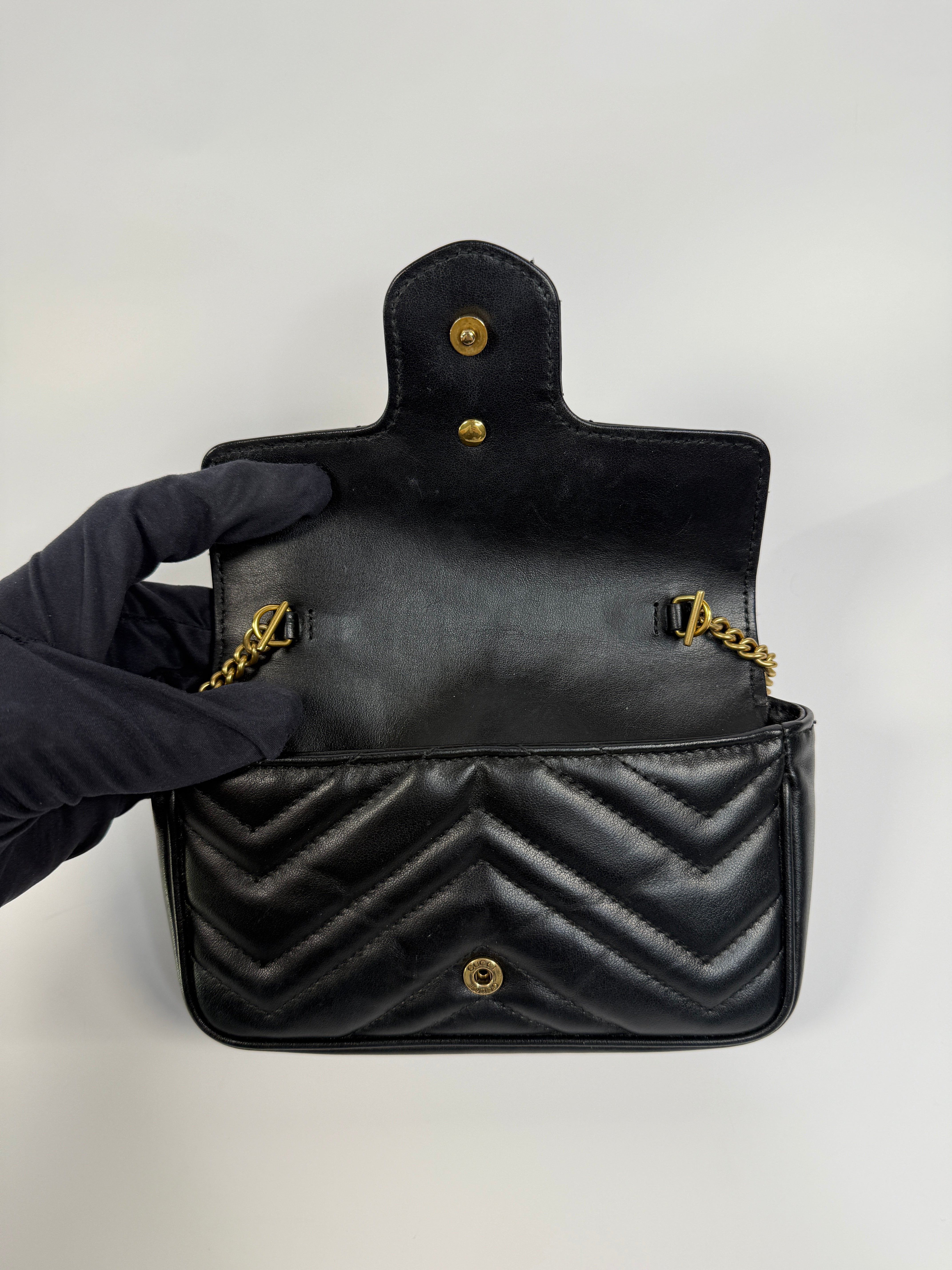 Authentic and preloved Gucci Marmont Matelassé Super Mini Bag In Black Leather With Gold Hardware in excellent condition 