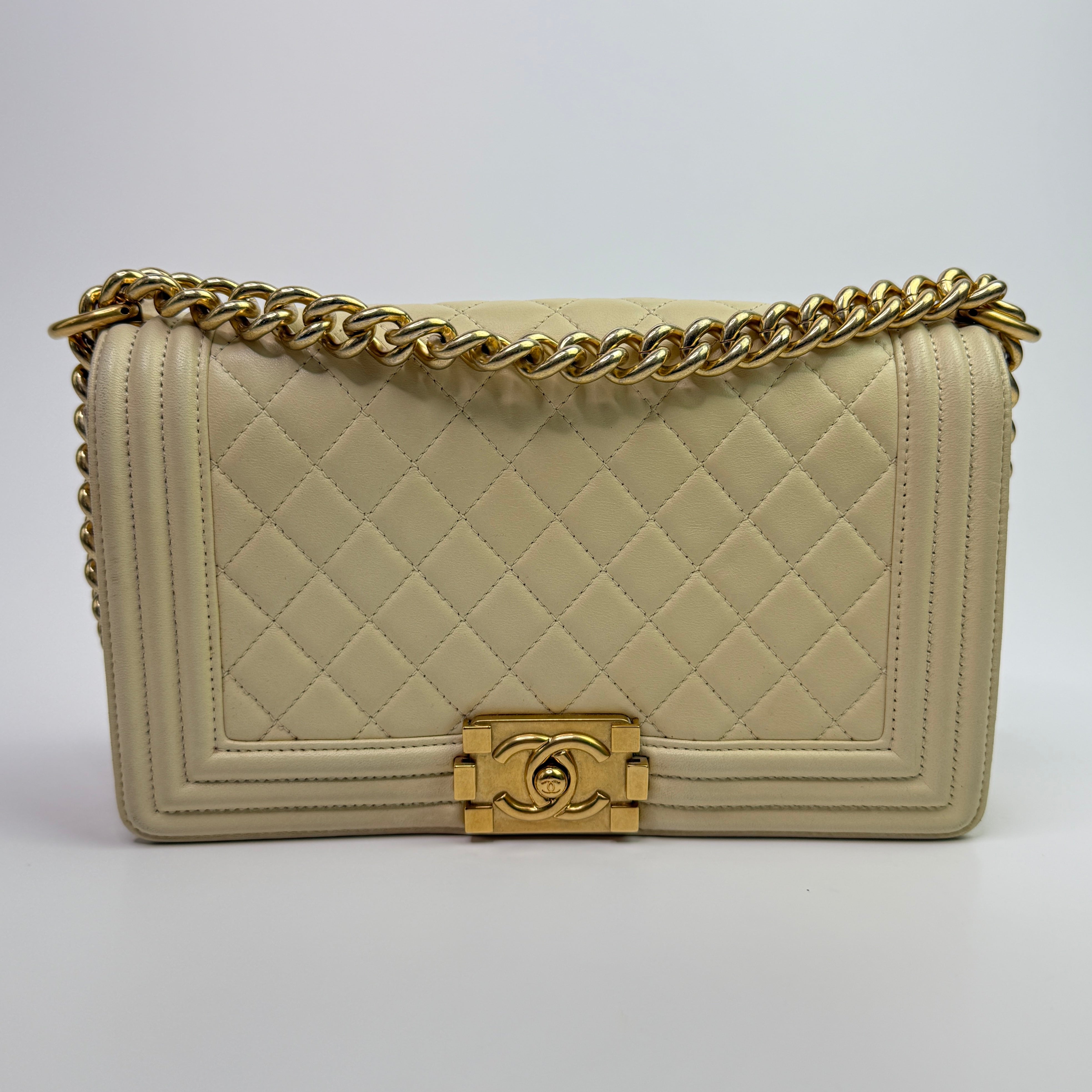 Authentic pre-loved Chanel Boy Bag Medium In Cream Lambskin With Gold Hardware. 