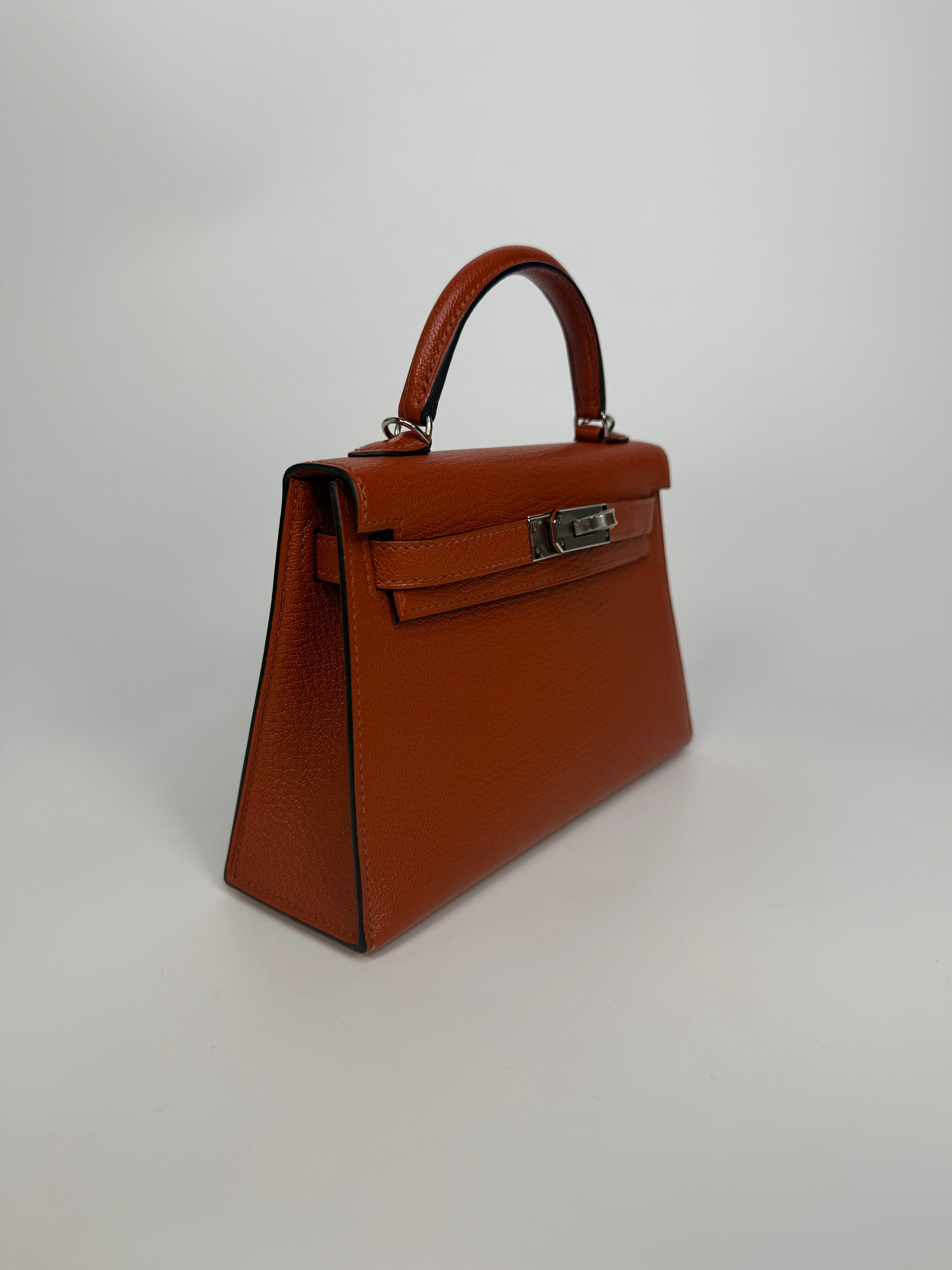 Hermès Mini Kelly In Cuivre Chèvre Mysore Leather With Palladium Hardware. Authentic and preloved in new and unused condition