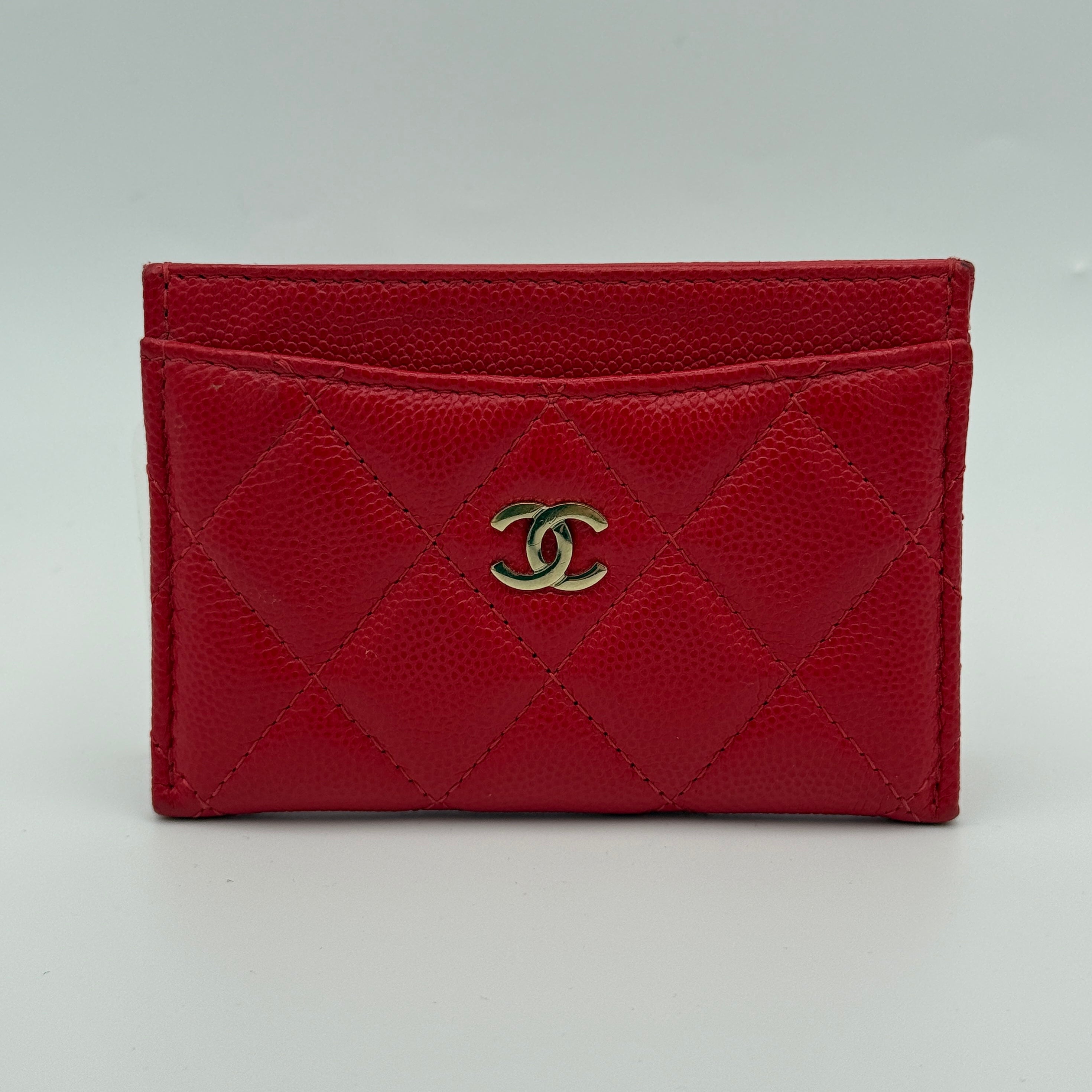 Authentic and preloved Chanel Classic Card Holder In Red Caviar Leather With Pale Gold Hardware In Excellent Condition. 100% Authenticity Guarantee 