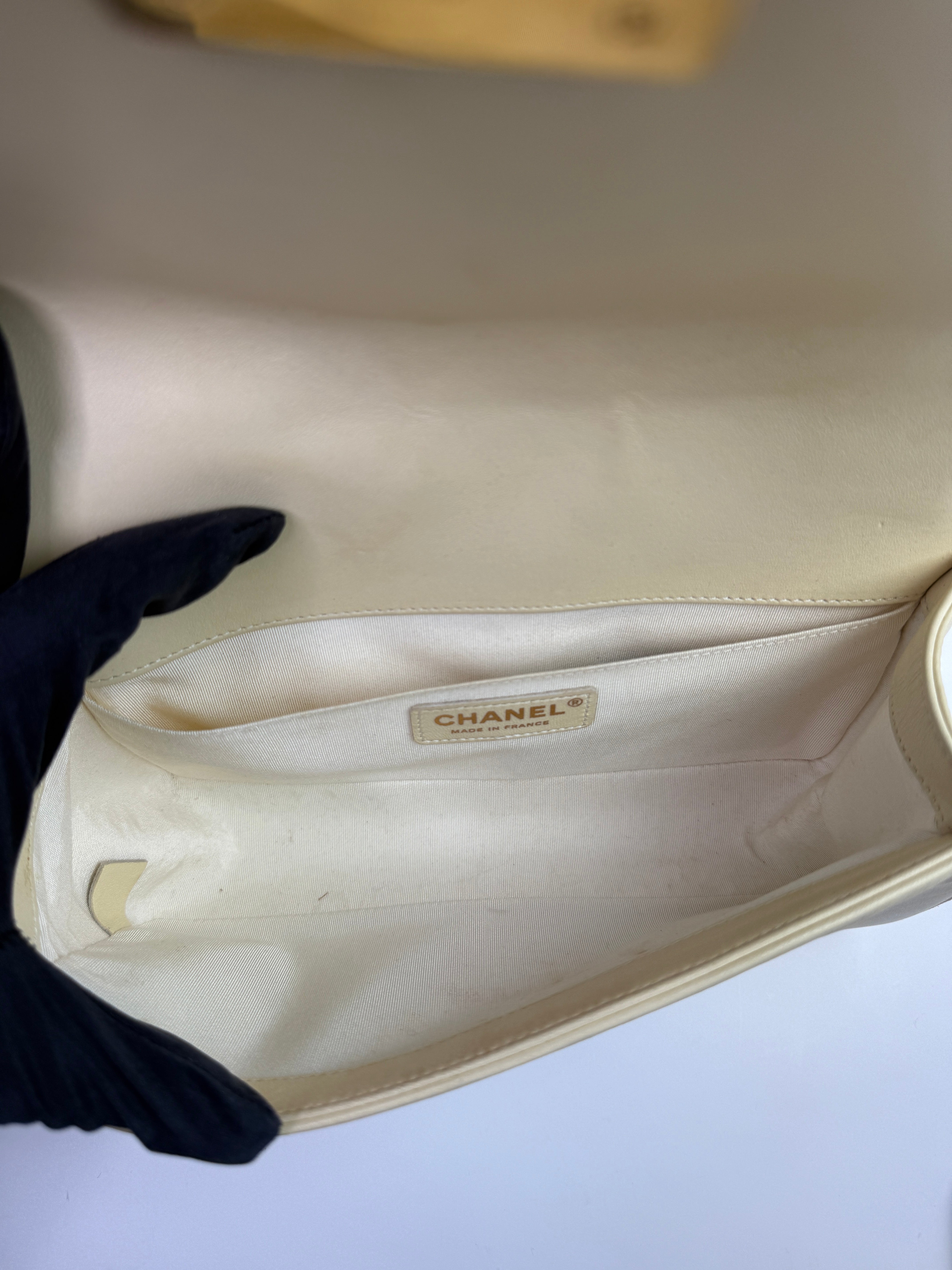 Authentic pre-loved Chanel Boy Bag Medium In Cream Lambskin With Gold Hardware. 