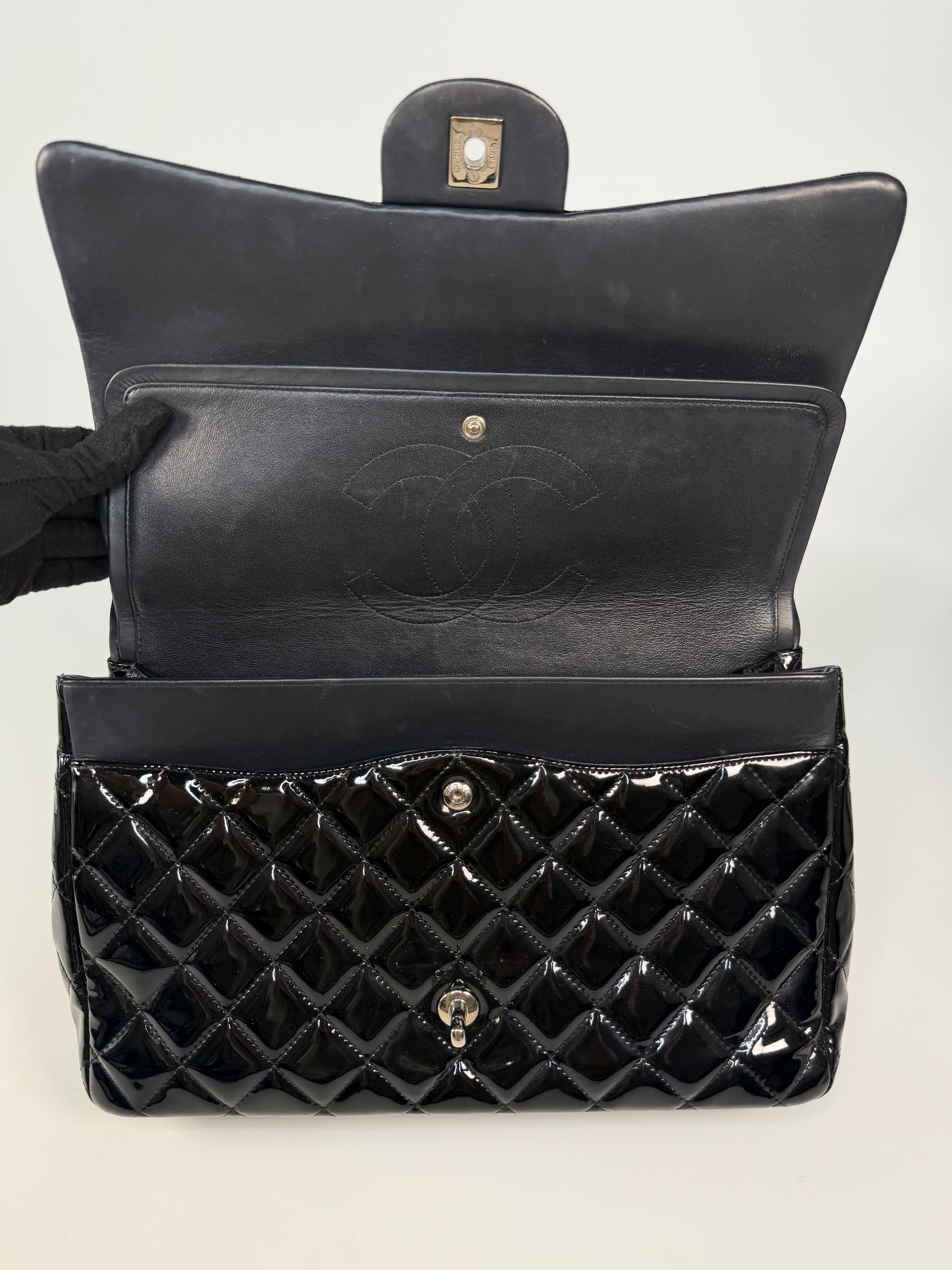 Chanel Maxi Classic Double Flap In Black Patent Leather With Silver Hardware. 100% authentic and preloved in excellent condition.