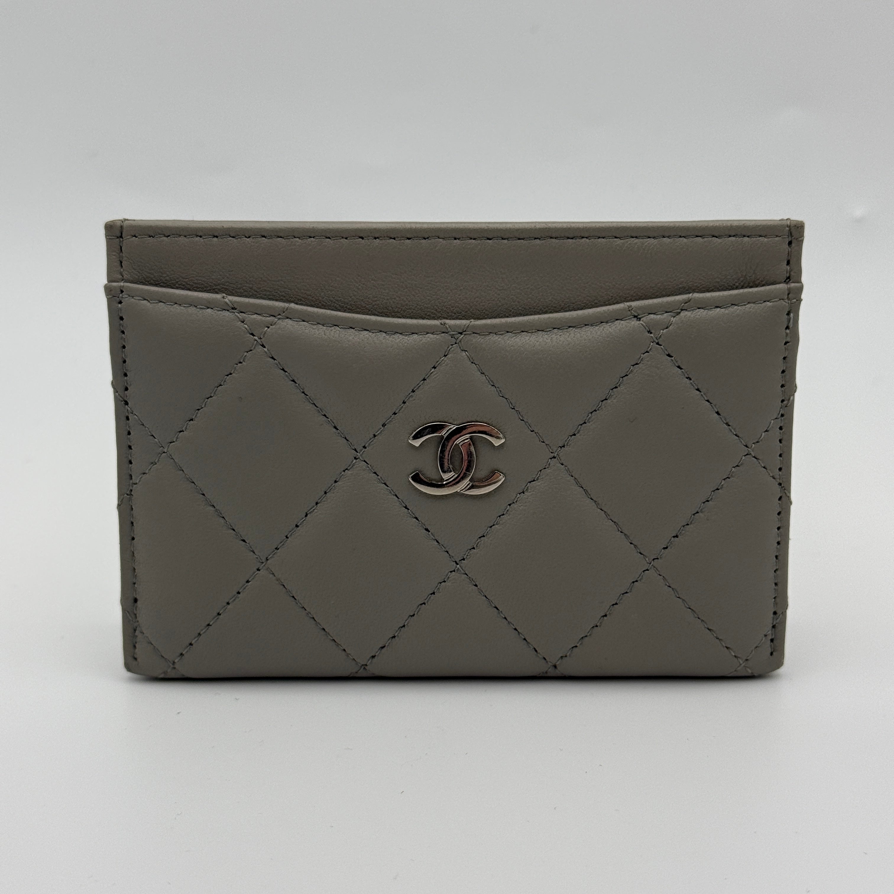 Authentic and pre loved Chanel Classic Card Holder In Grey Lambskin Leather With Silver hardware. Excellent Condition. 100% Authenticity guarantee. 