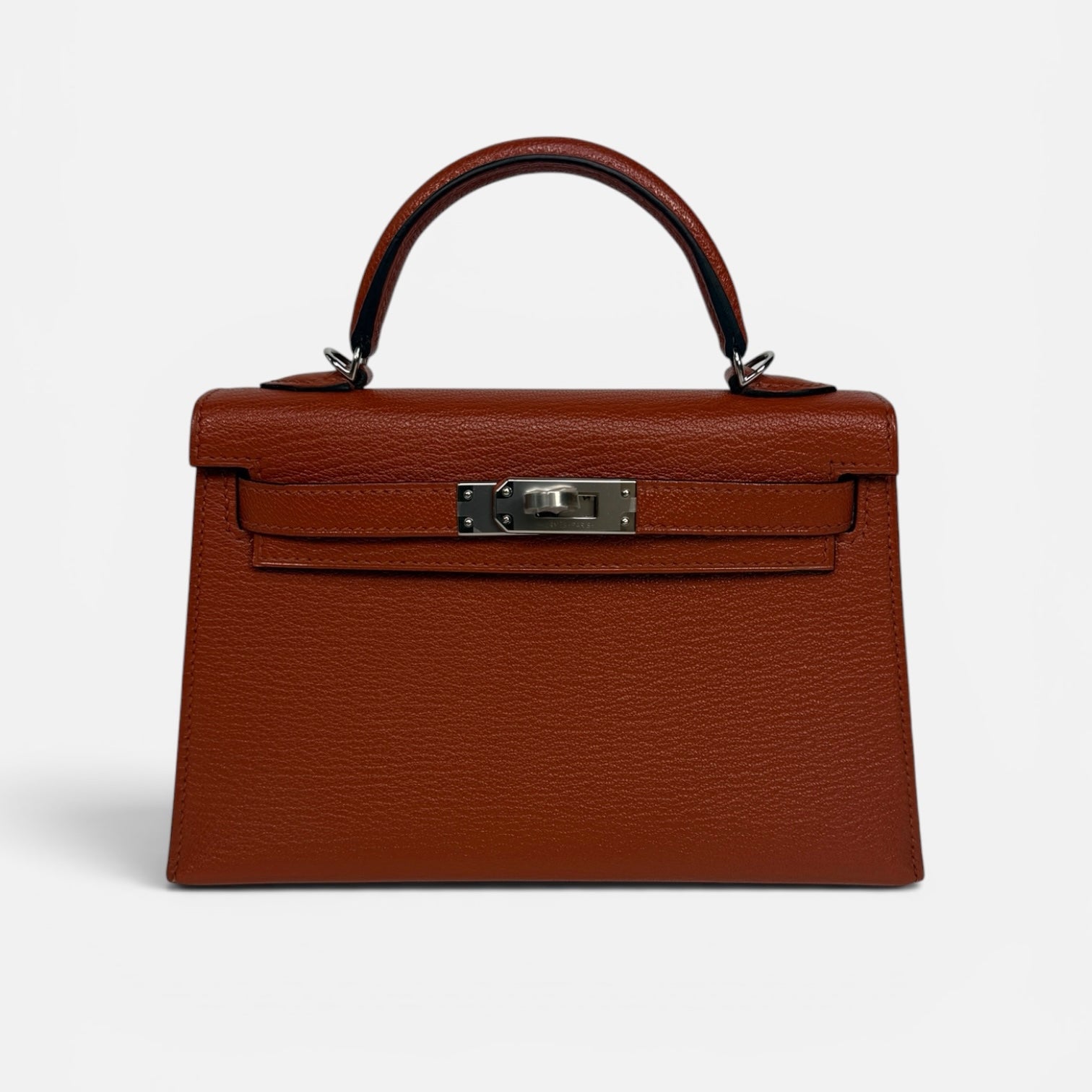 Hermès Mini Kelly In Cuivre Chèvre Mysore Leather With Palladium Hardware. Authentic and preloved in new and unused condition