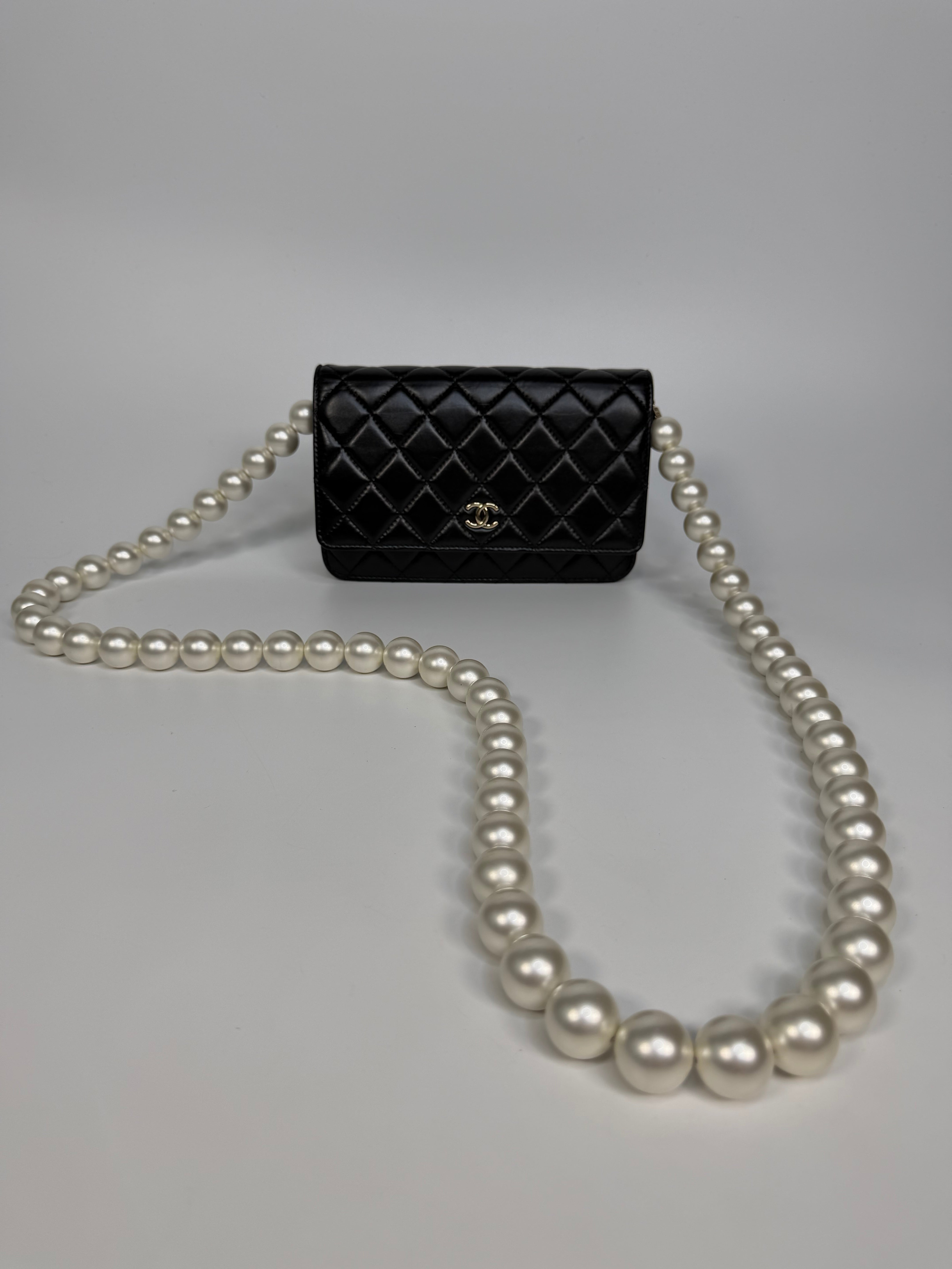 Chanel Pearl Wallet On Chain In Black Lambskin Leather With Gold Hardware. Authentic and preloved in very good condition.