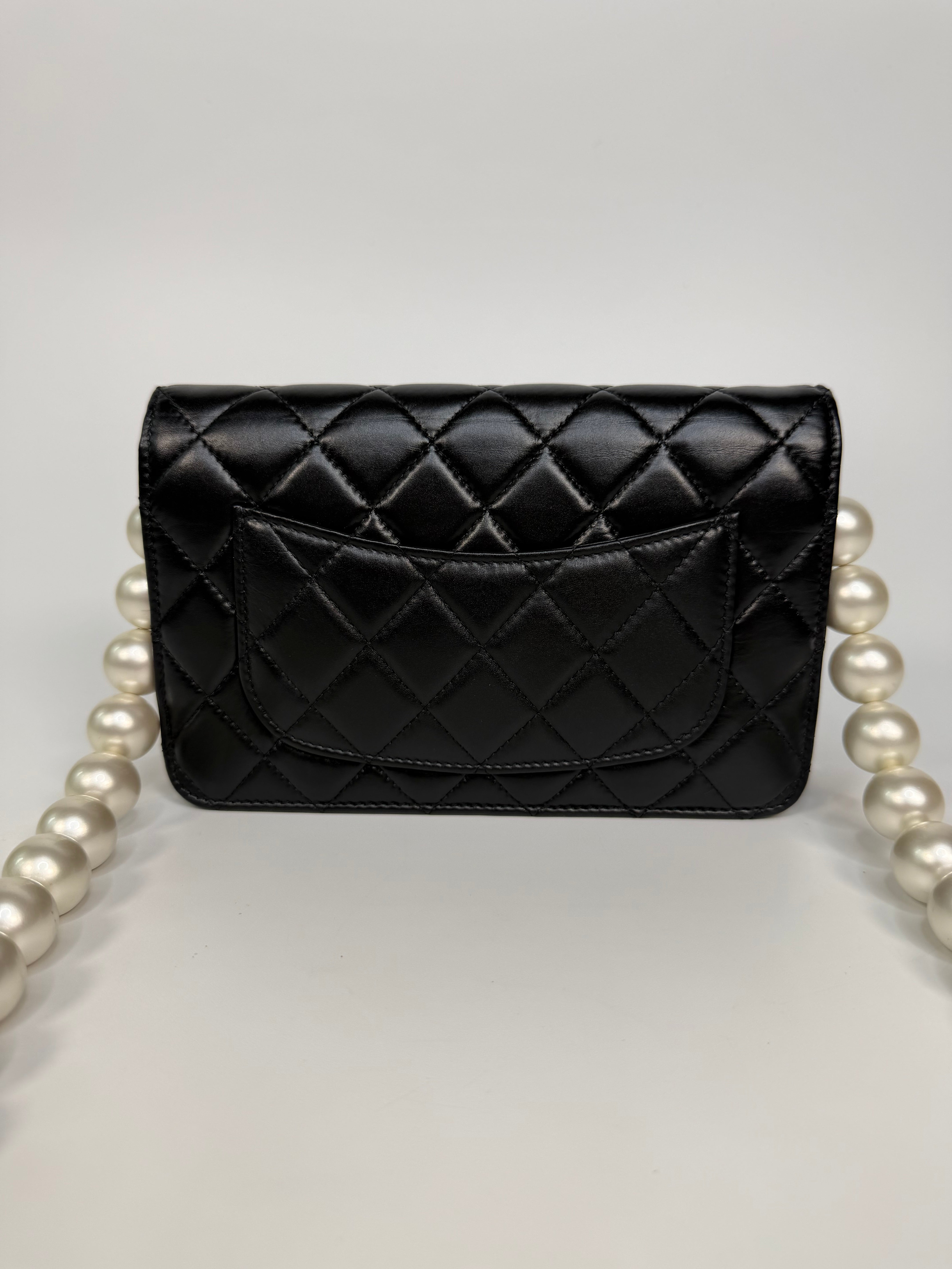 Chanel Pearl Wallet On Chain In Black Lambskin Leather With Gold Hardware. Authentic and preloved in very good condition.