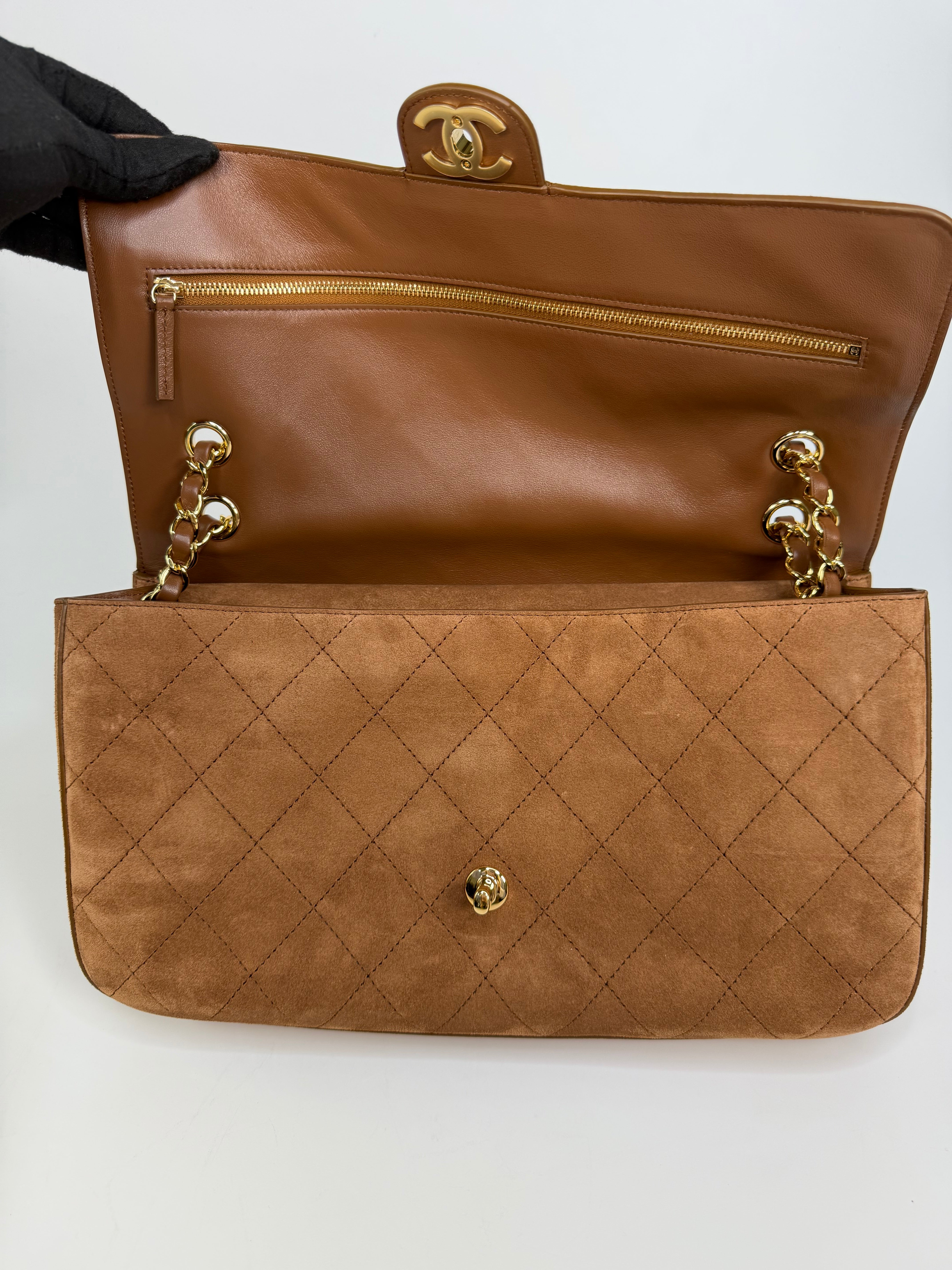 Chanel Maxi Flap In Tan Suede With Gold Hardware. Authentic and preloved in new and unused condition.
