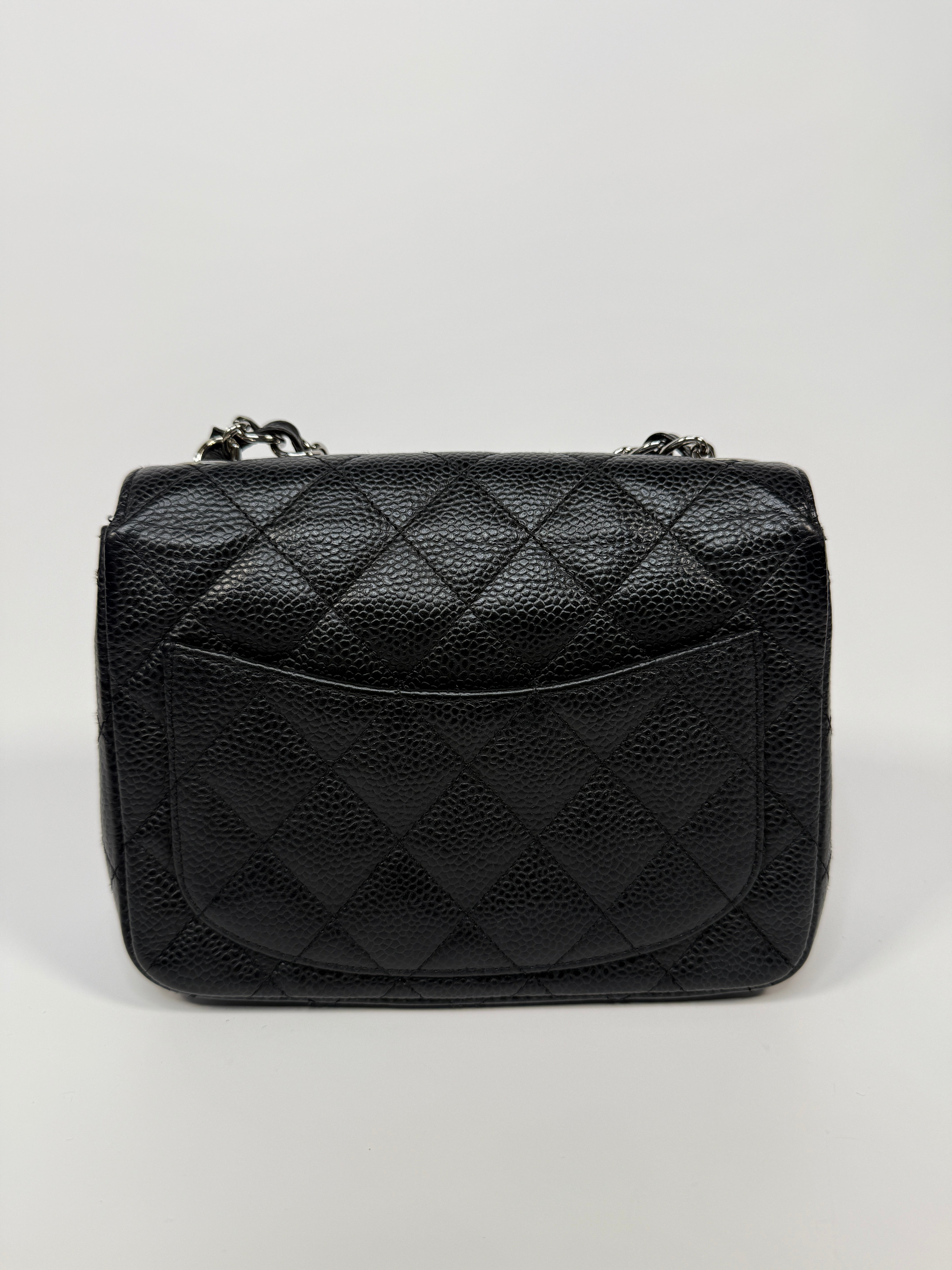 Chanel Black Square Flap Bag In Black Caviar Leather With Silver Hardware. Excellent condition. Authentic and preloved.