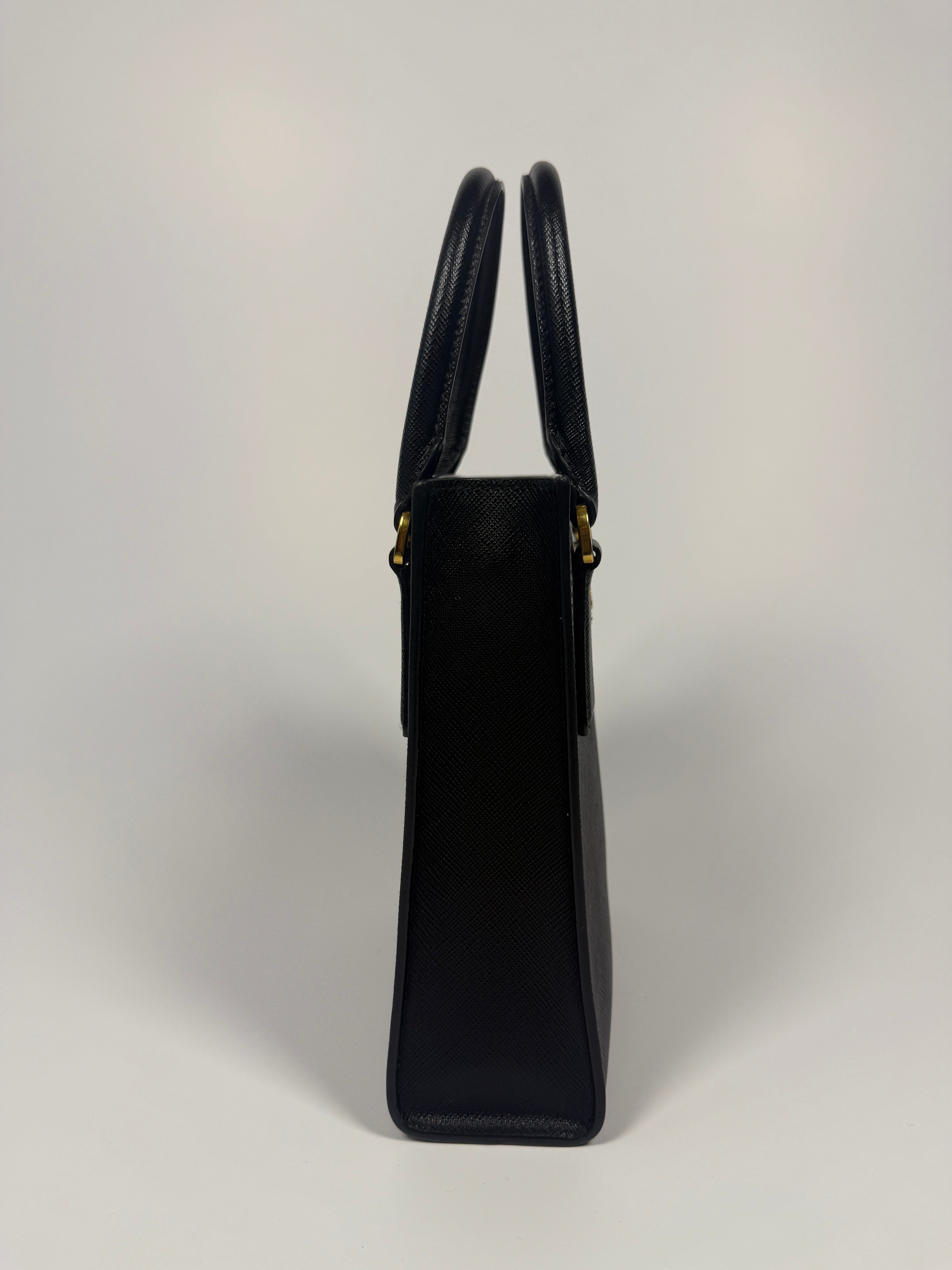 Prada Mini Tote In Black Saffiano Leather With Gold Hardware. 100% Authentic and preloved in excellent conditionPrada Mini Tote In Black Saffiano Leather With Gold Hardware. 100% Authentic and preloved in excellent condition