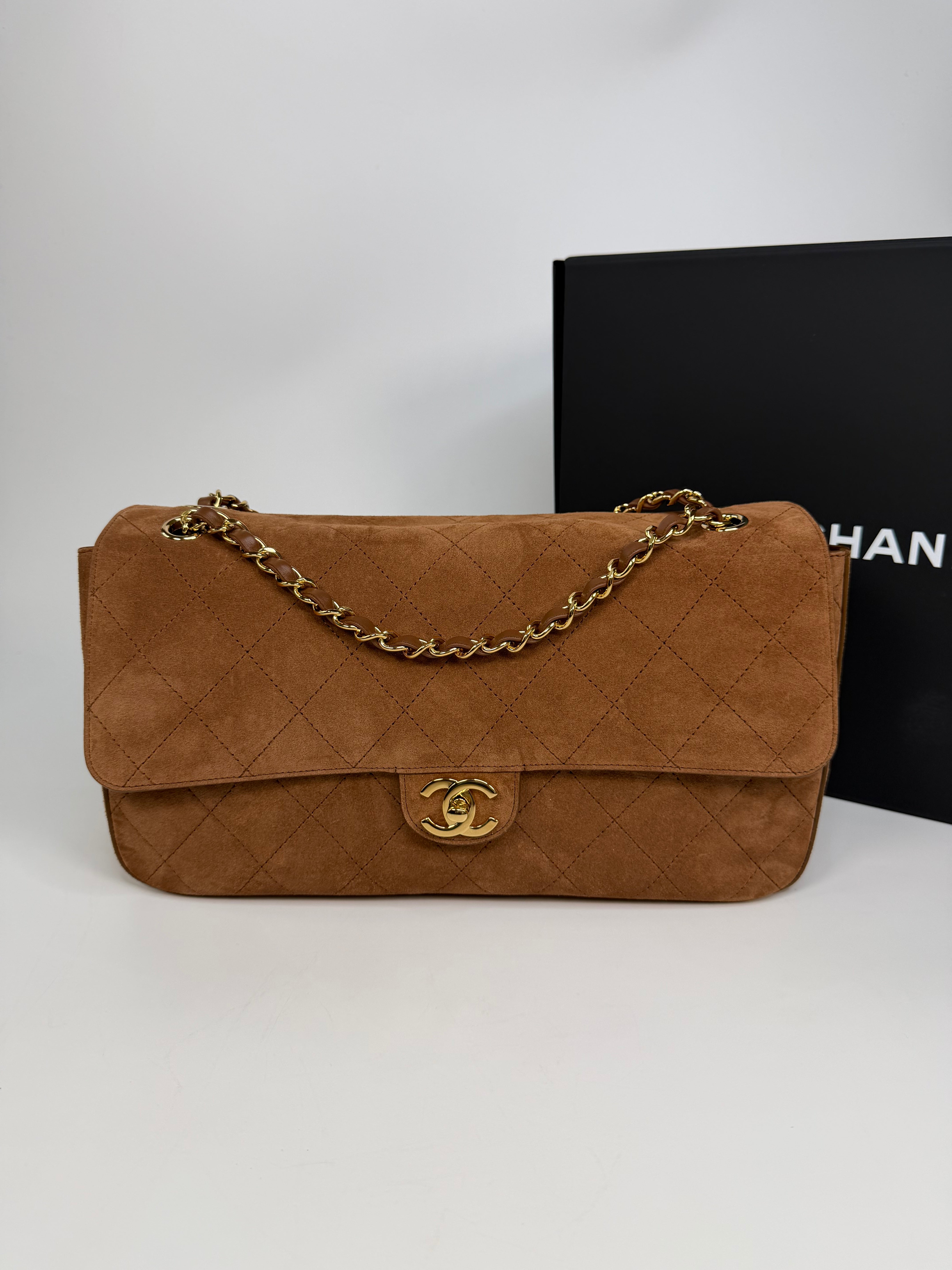 Chanel Maxi Flap In Tan Suede With Gold Hardware. Authentic and preloved in new and unused condition.