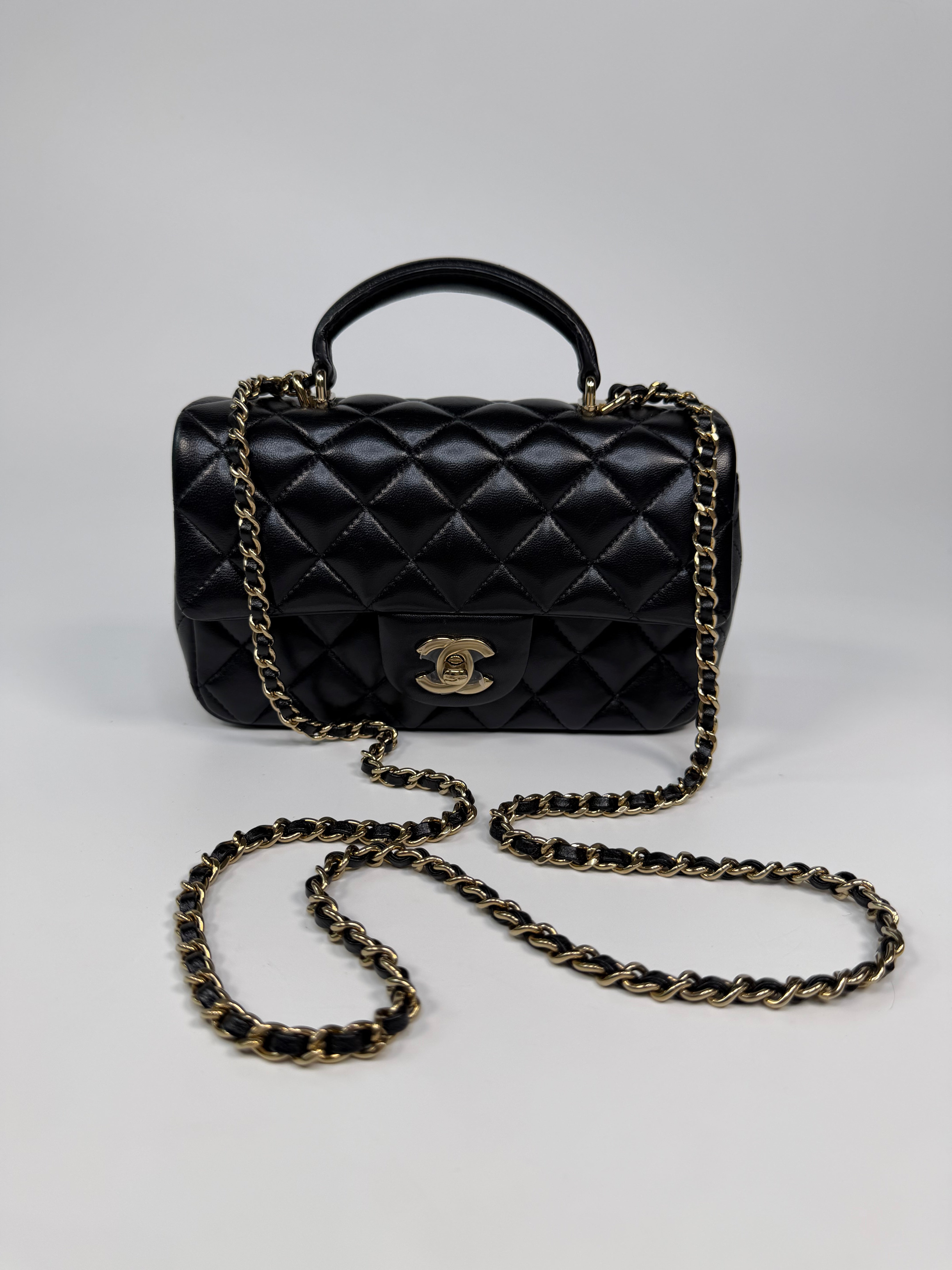 Chanel Mini Rectangle Top Handle In Black Lambskin Leather With Pale Gold Hardware. Authentic and preloved in excellent condition.