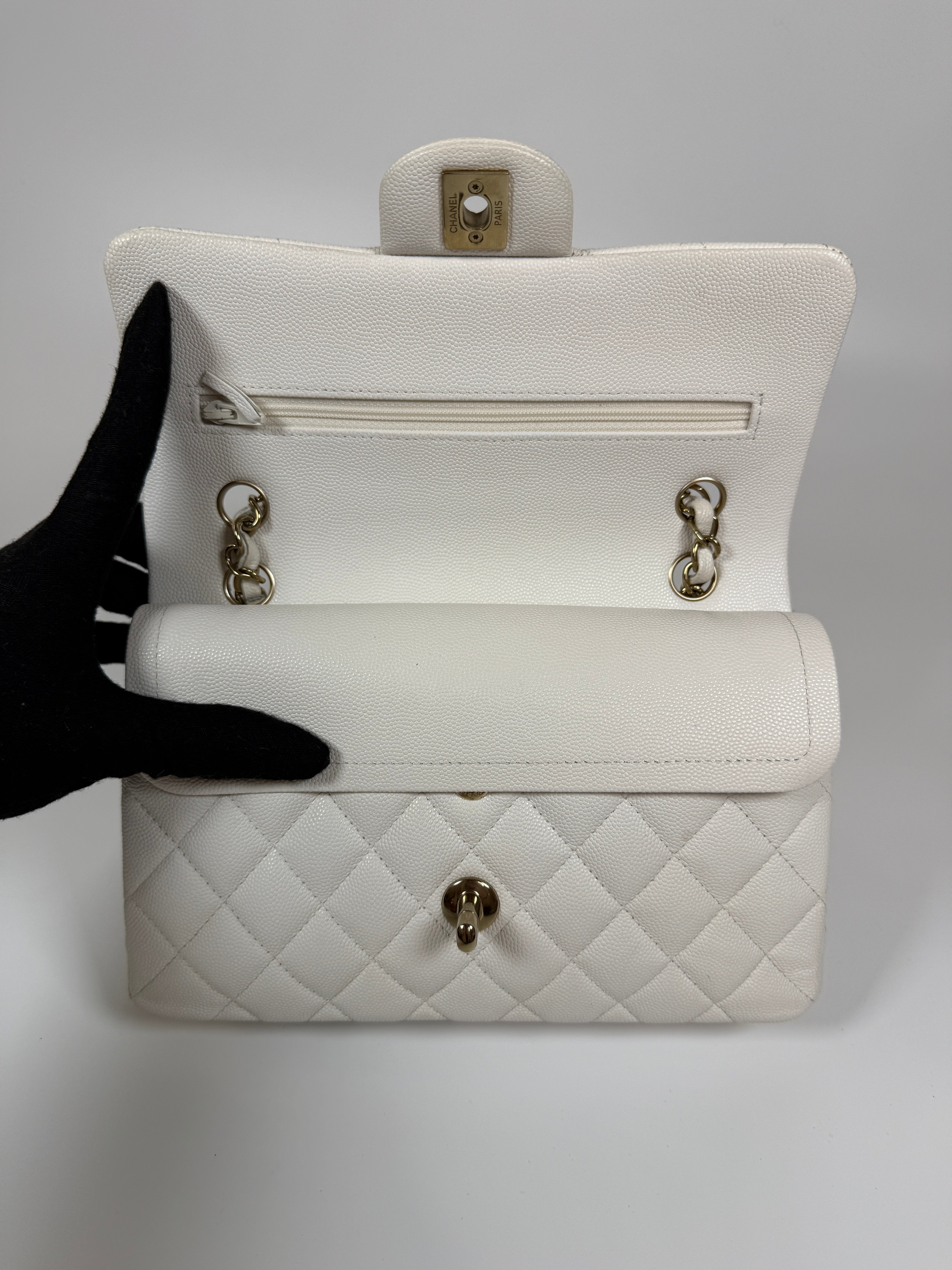 Authentic and preloved Chanel Small Classic Double Flap In White Caviar Leather With pale gold hardware. Very Good Condition. 100% Authenticity guarantee 